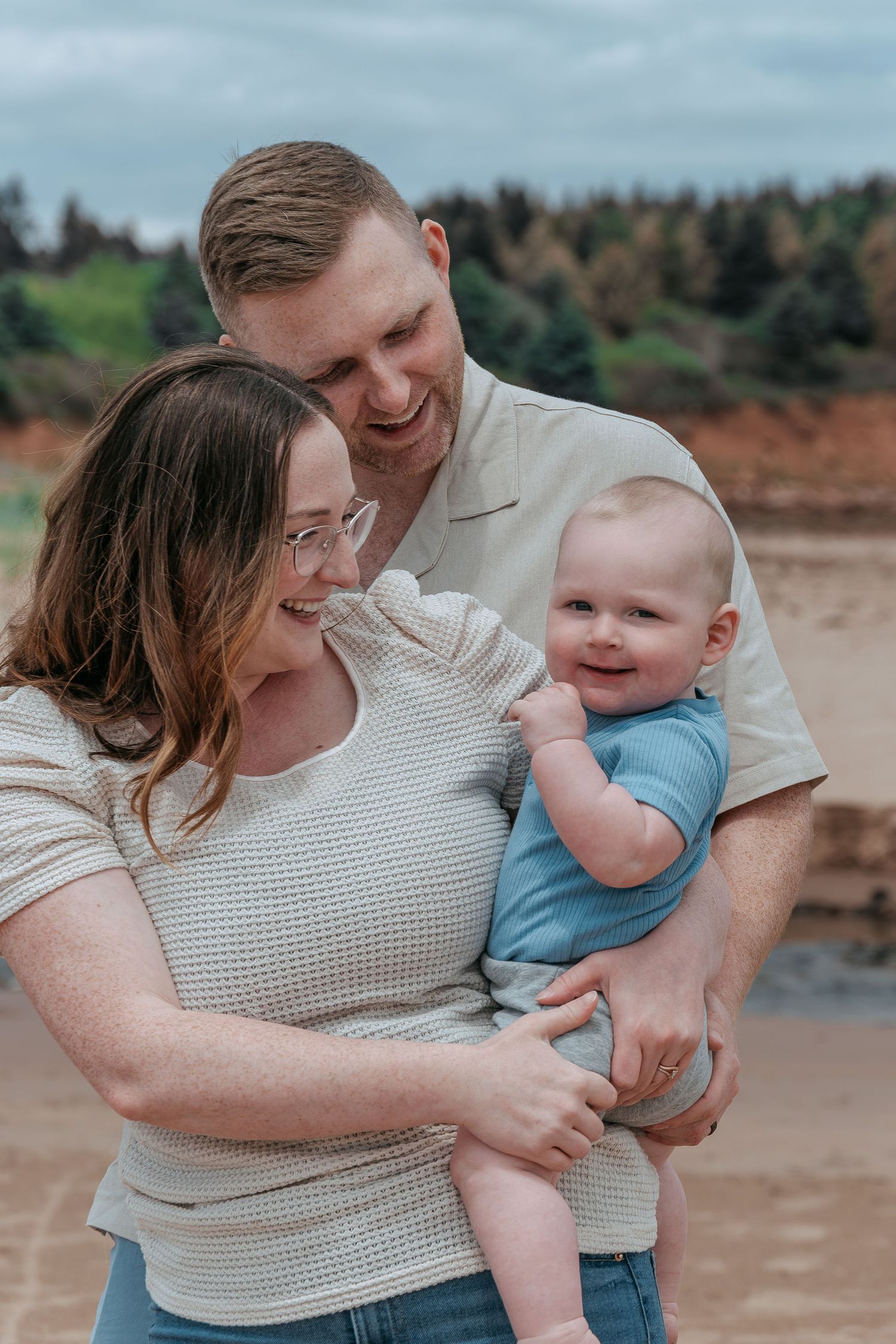 Family photography session capturing parents and children together on Prince Edward Island beach.