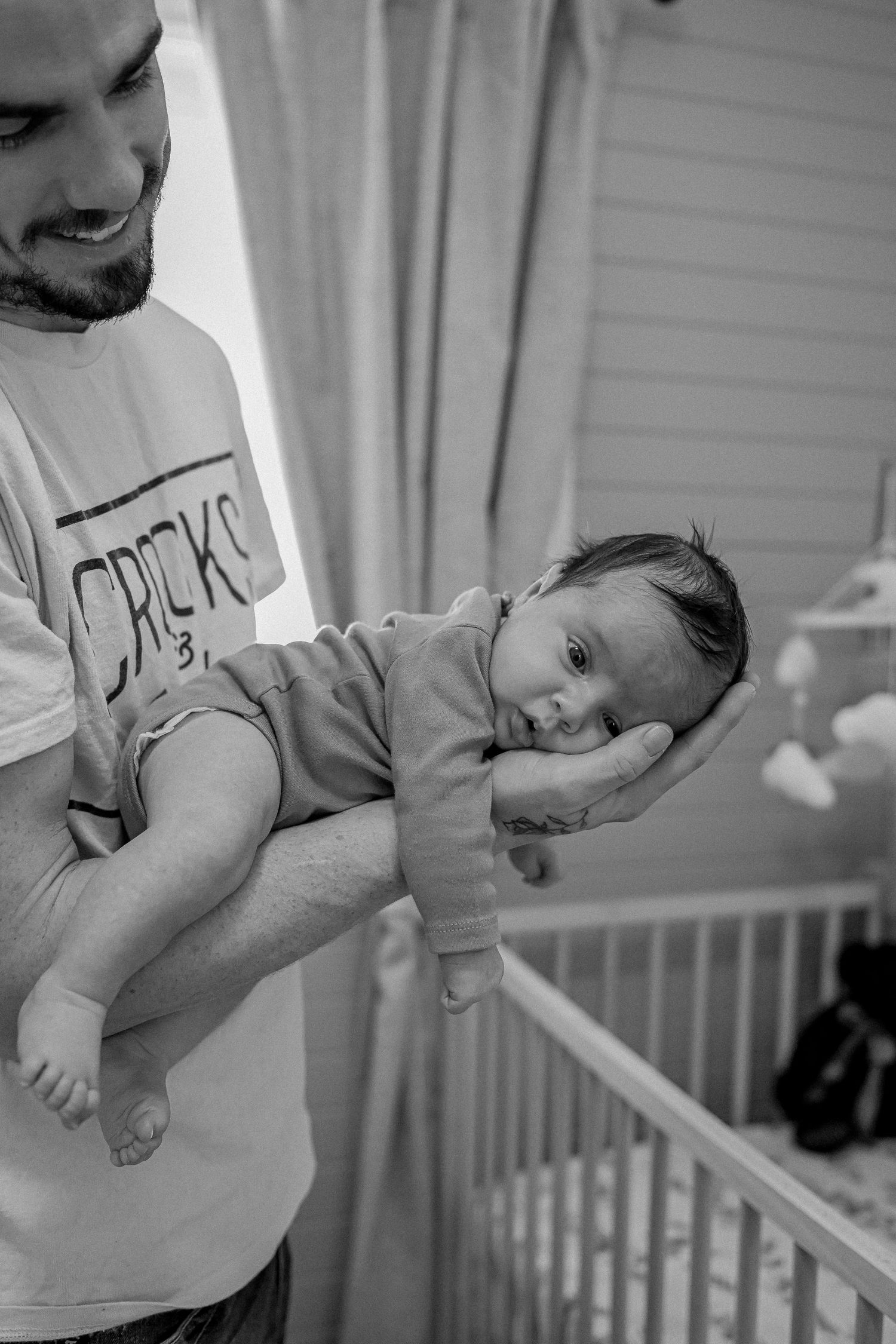 Documentary-style newborn photography session in a Nova Scotia home.
