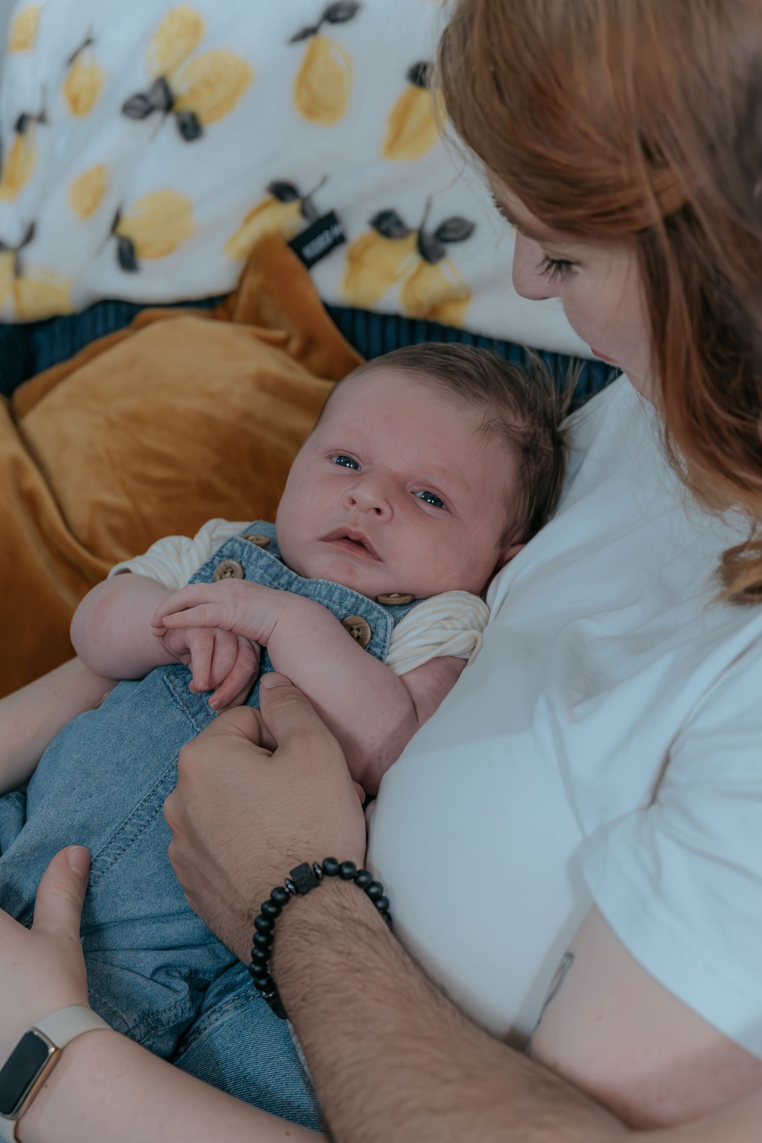 In-home lifestyle newborn photography of a baby resting peacefully on her mother.