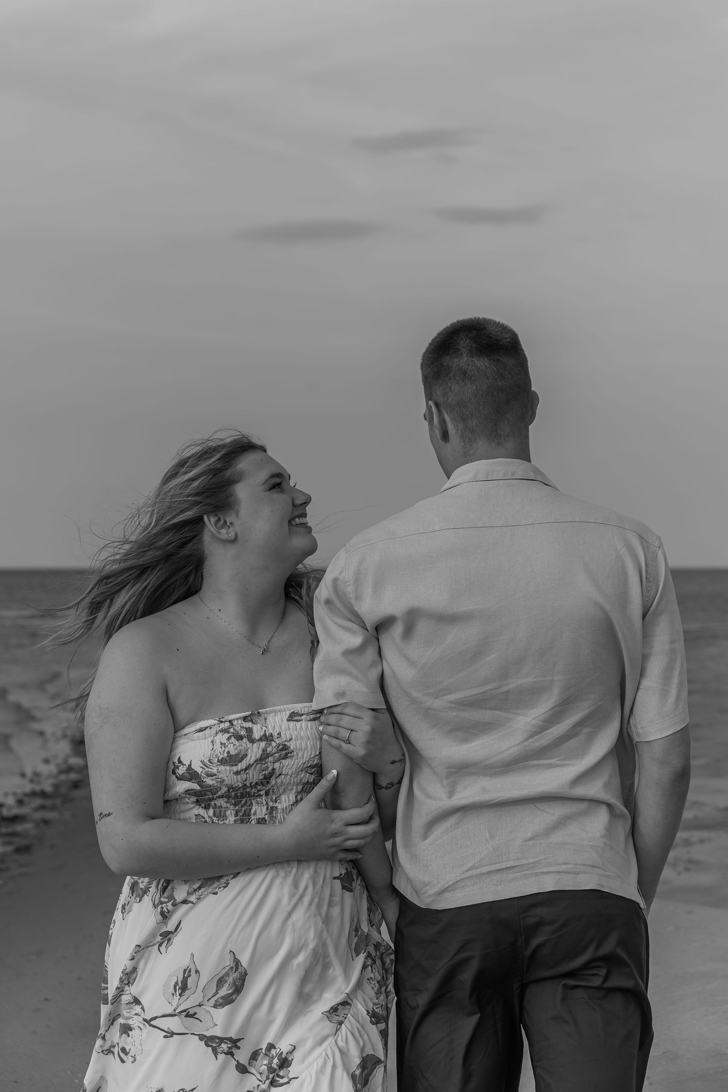 Couple portrait captured on the beach with ocean backdrop