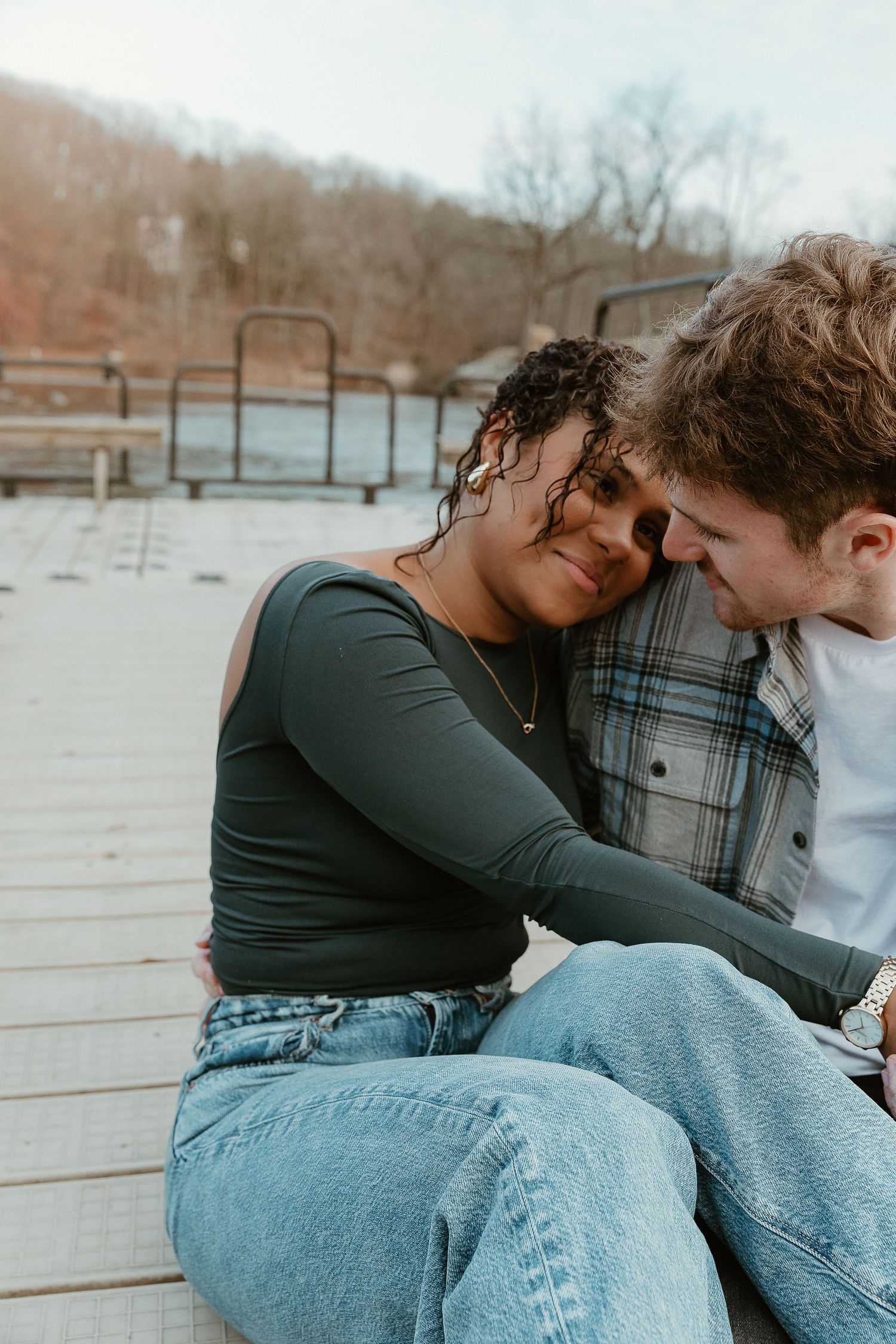 Close-up storytelling couple moment on a dock, leaning in with soft smiles, edited in warm, nostalgic film tones.