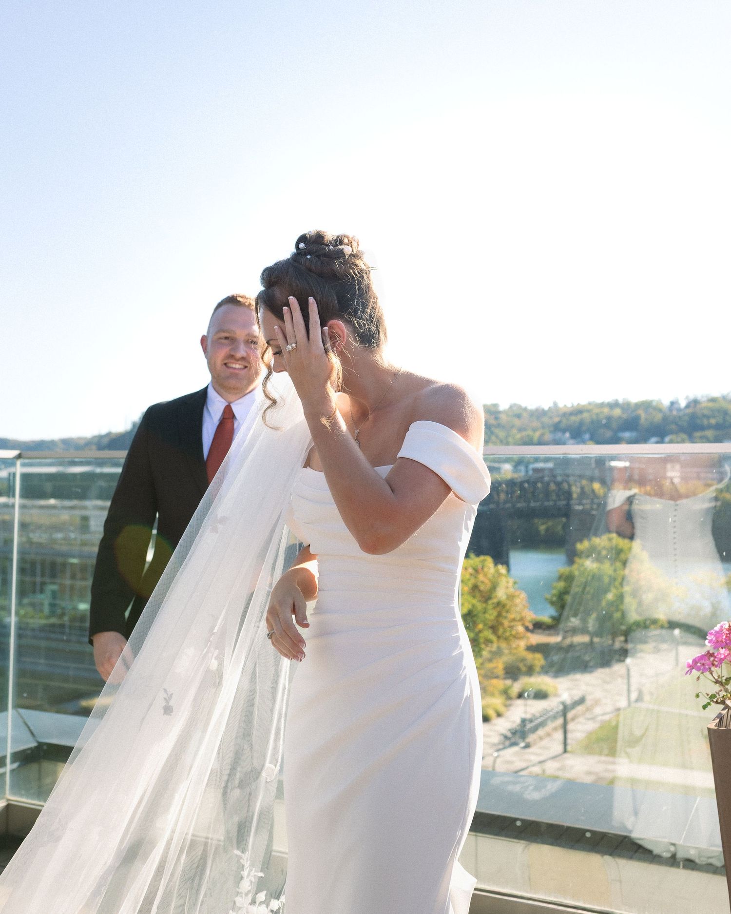 A series of wedding photos showing a couple in formal attire sharing candid moments on a balcony overlooking water.