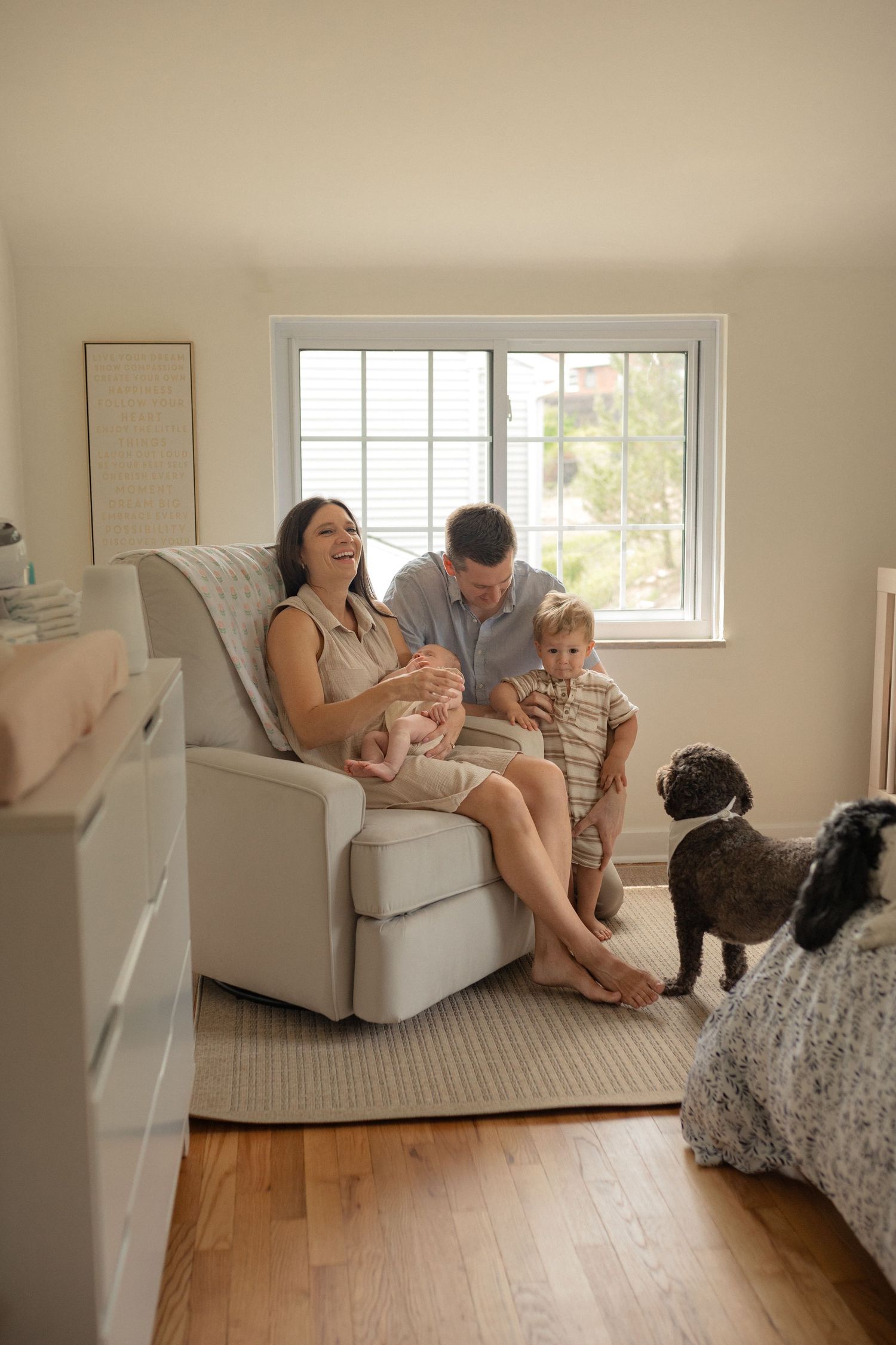 Family relaxing together in a bright living room with dogs.