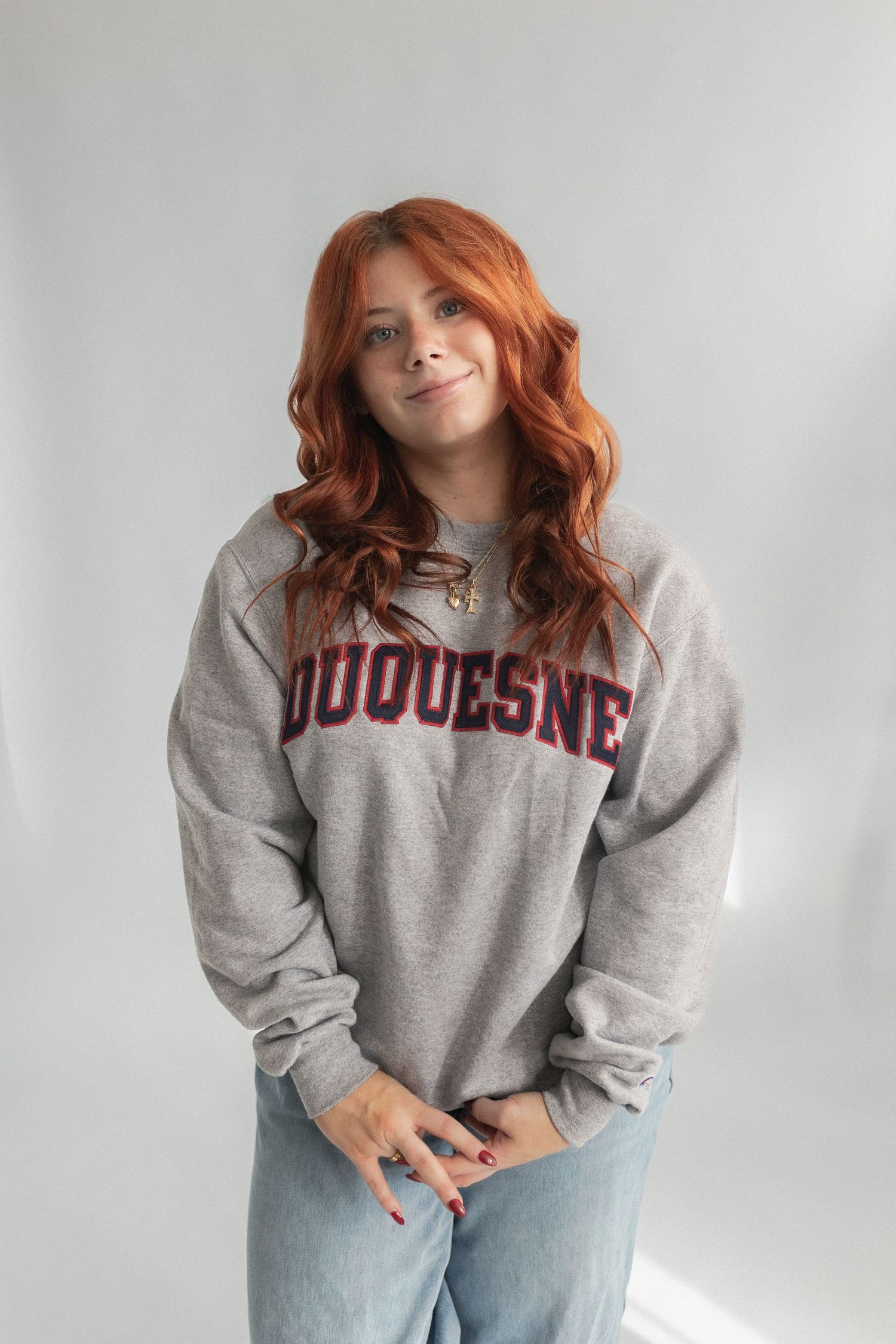 Casual portrait wearing grey Duquesne university sweatshirt and jeans.