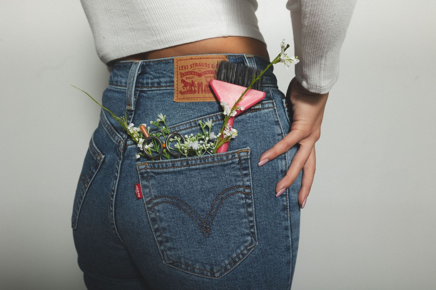 Flowers tucked into the back pocket of vintage Levi's jeans.