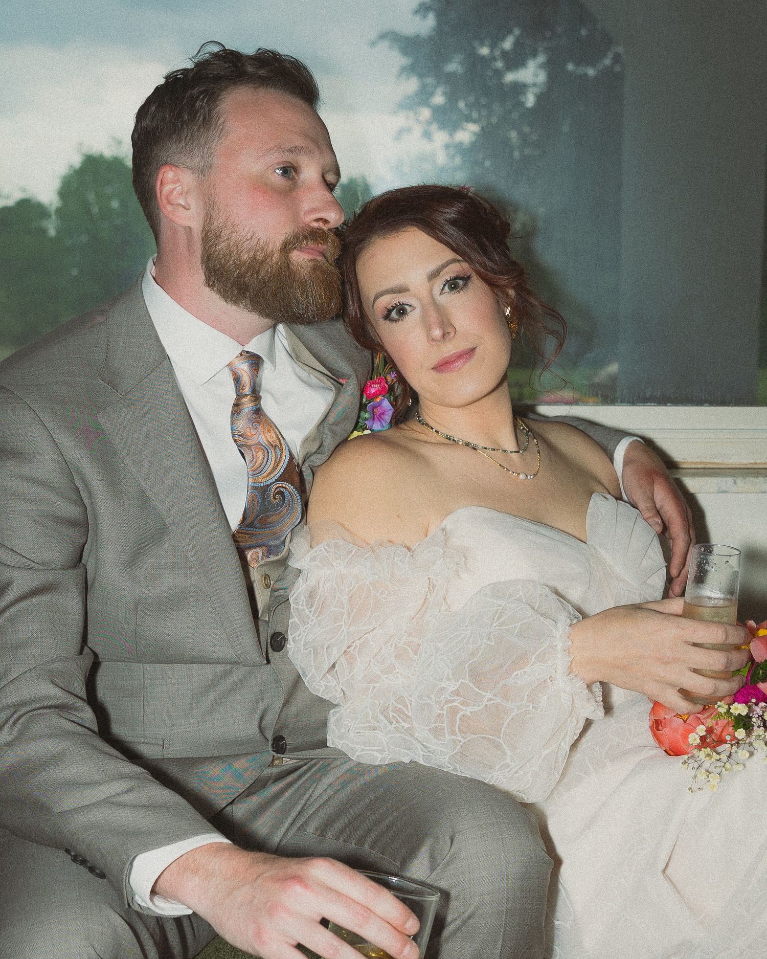 A couple in wedding attire share intimate moments while sitting together in a series of romantic portrait photos.