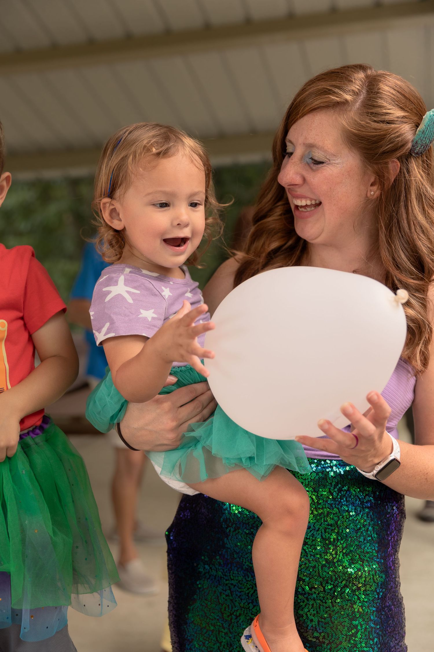 A joyful celebration with sparkling decorations, white balloons, and festive attire.