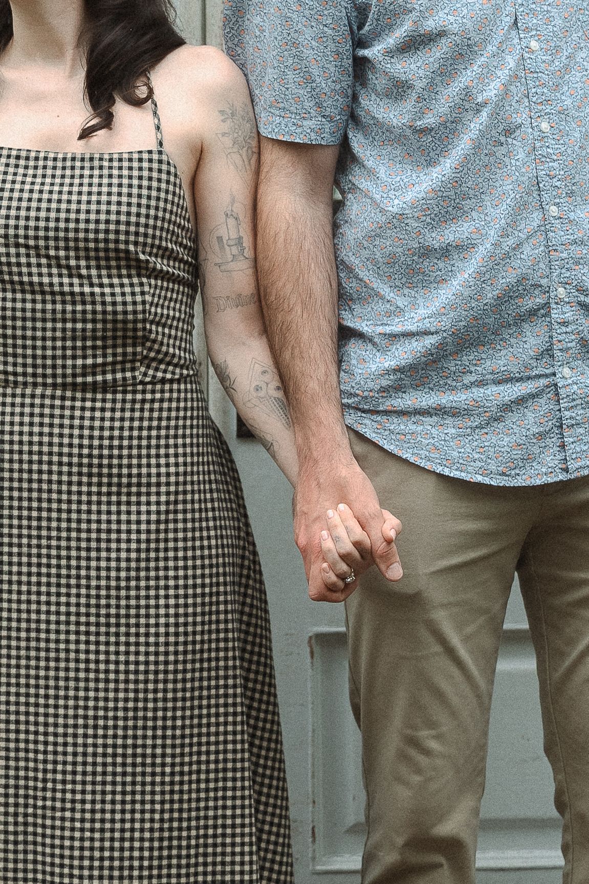 A sequence of cropped images showing two people holding hands together against a gray background.
