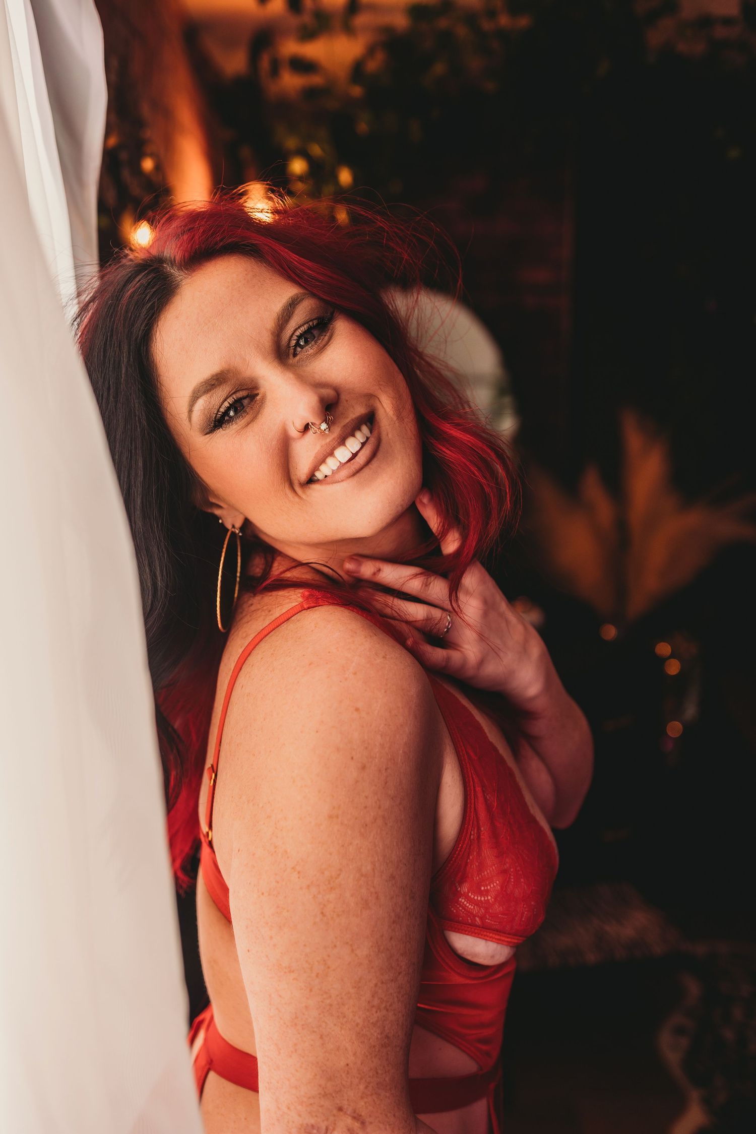 A series of photos showing someone in a red top posing playfully against a dark background with warm lighting.