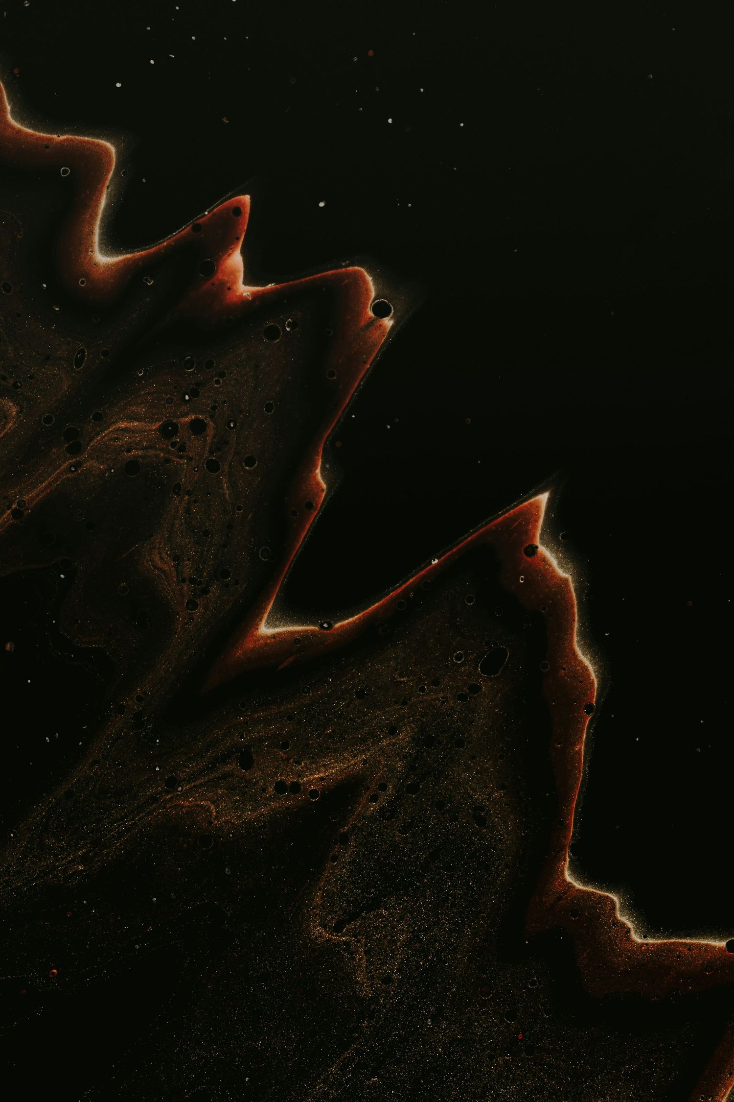 Abstract orange glowing lines and curves against a dark background create a dynamic nebula-like pattern.