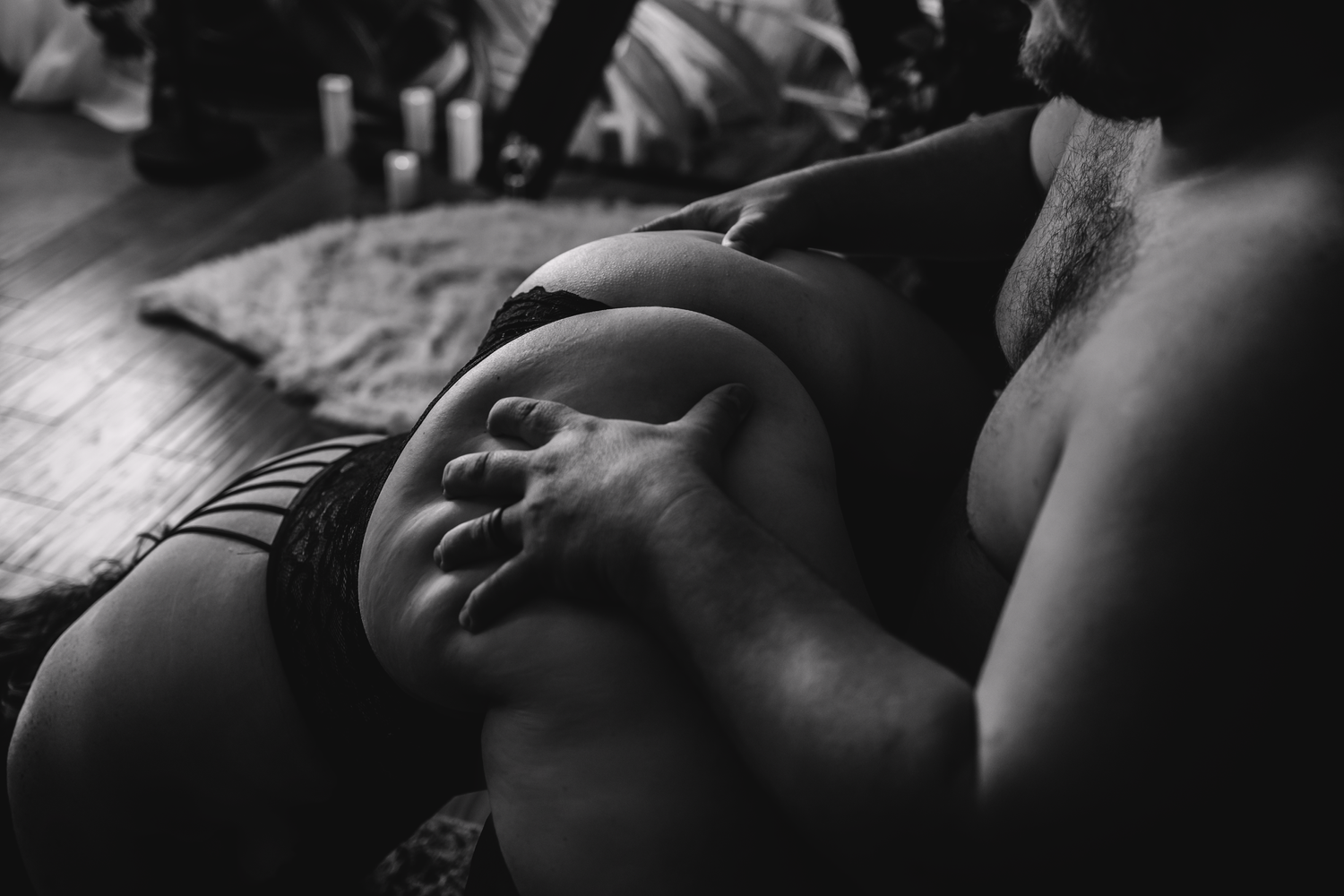 Black and white intimate closeup photograph showing relaxed peaceful expression in dramatic lighting during boudoir photoshoot.