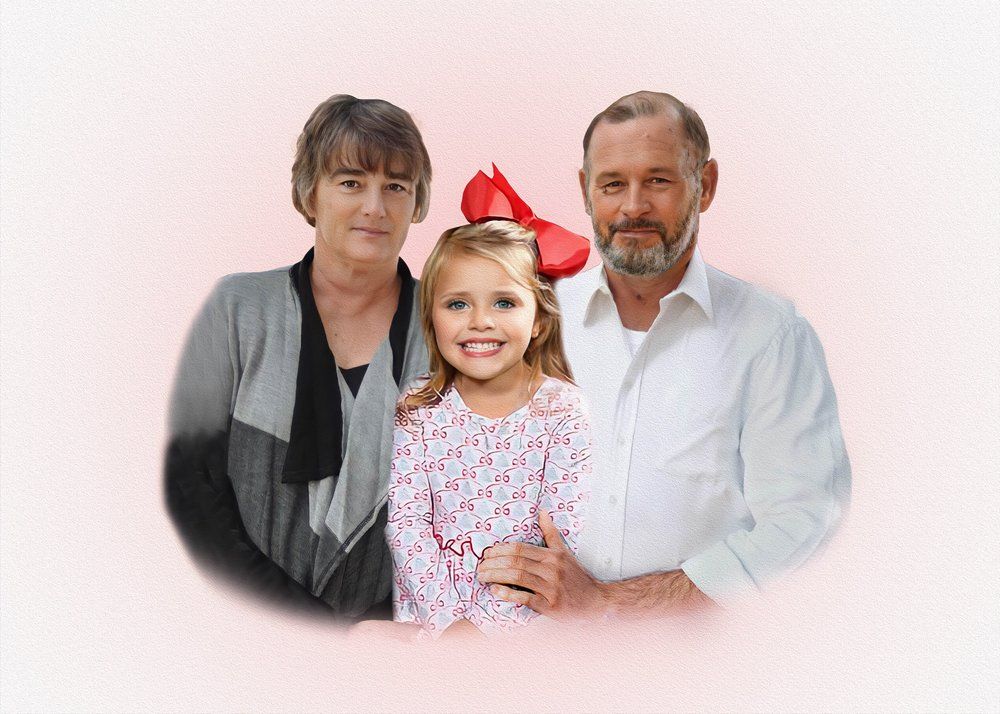 Family portrait against pink background showing three generations together.
