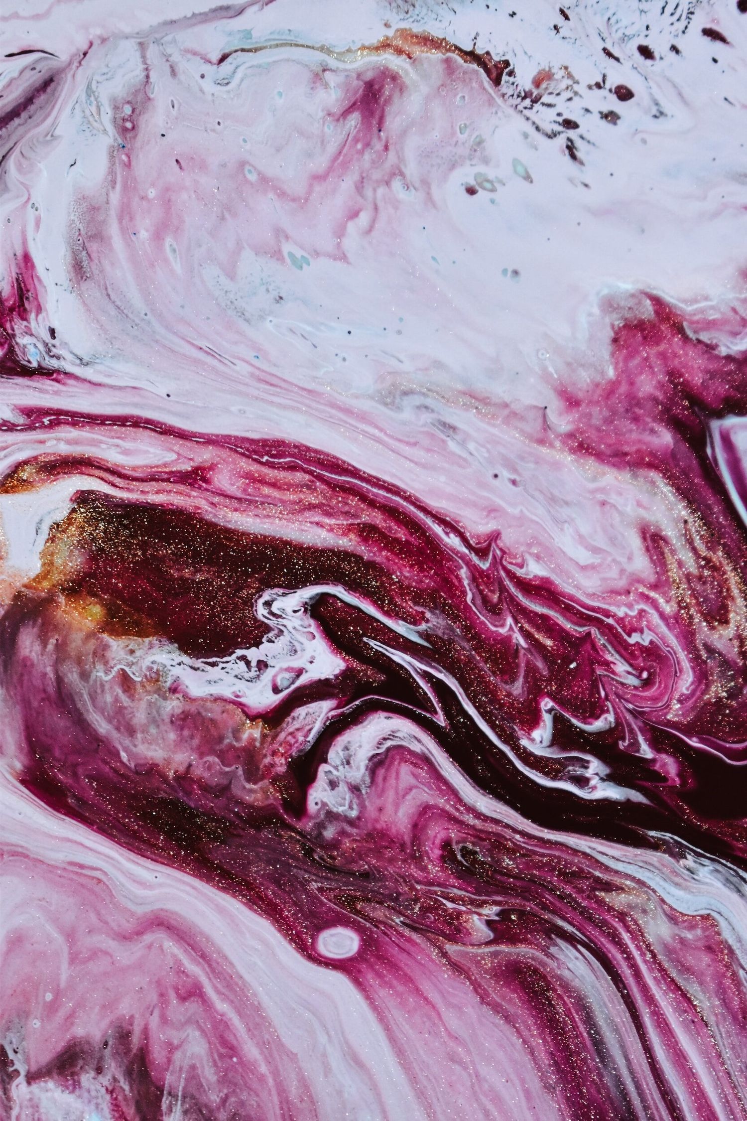 Abstract fluid art with swirling patterns in pink, white and burgundy colors.