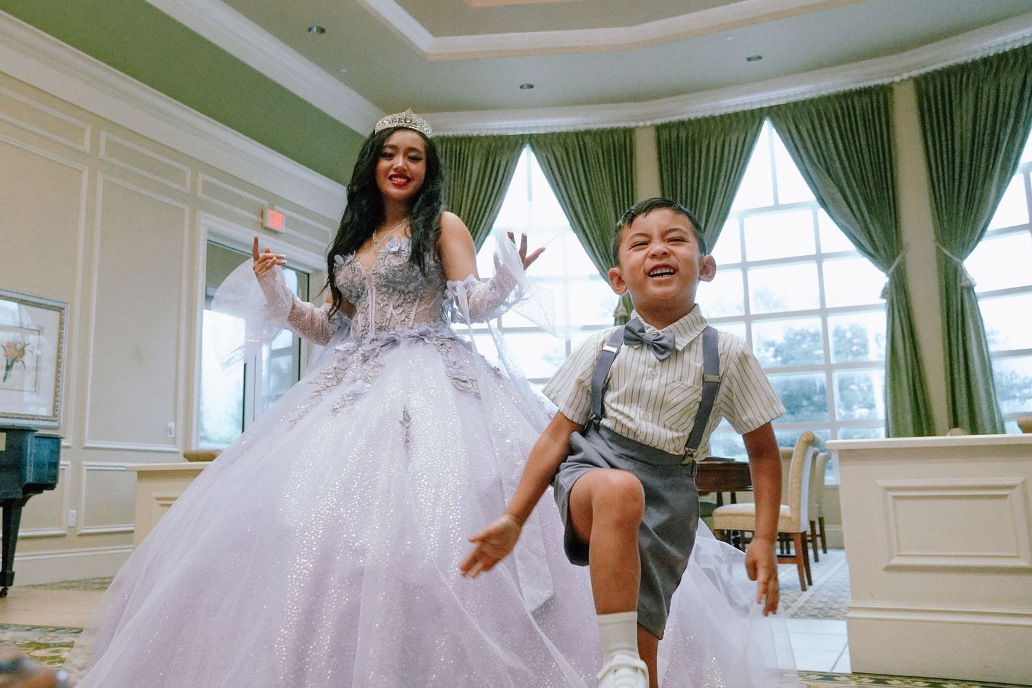 A celebratory moment in an elegant room with a flowing white ballgown and formal attire.