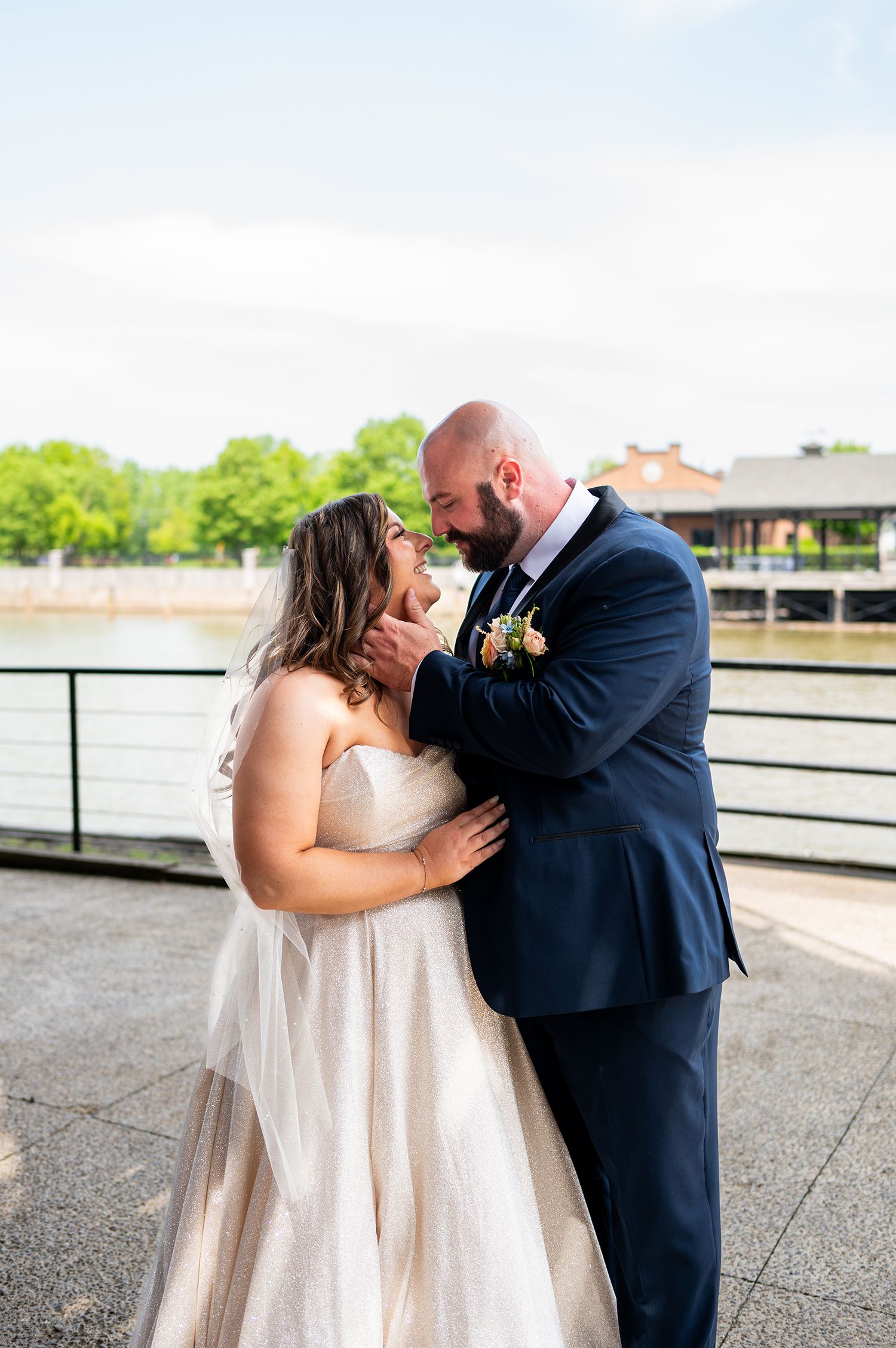 A couple shares a romantic kiss sequence on their wedding day on a rooftop terrace.