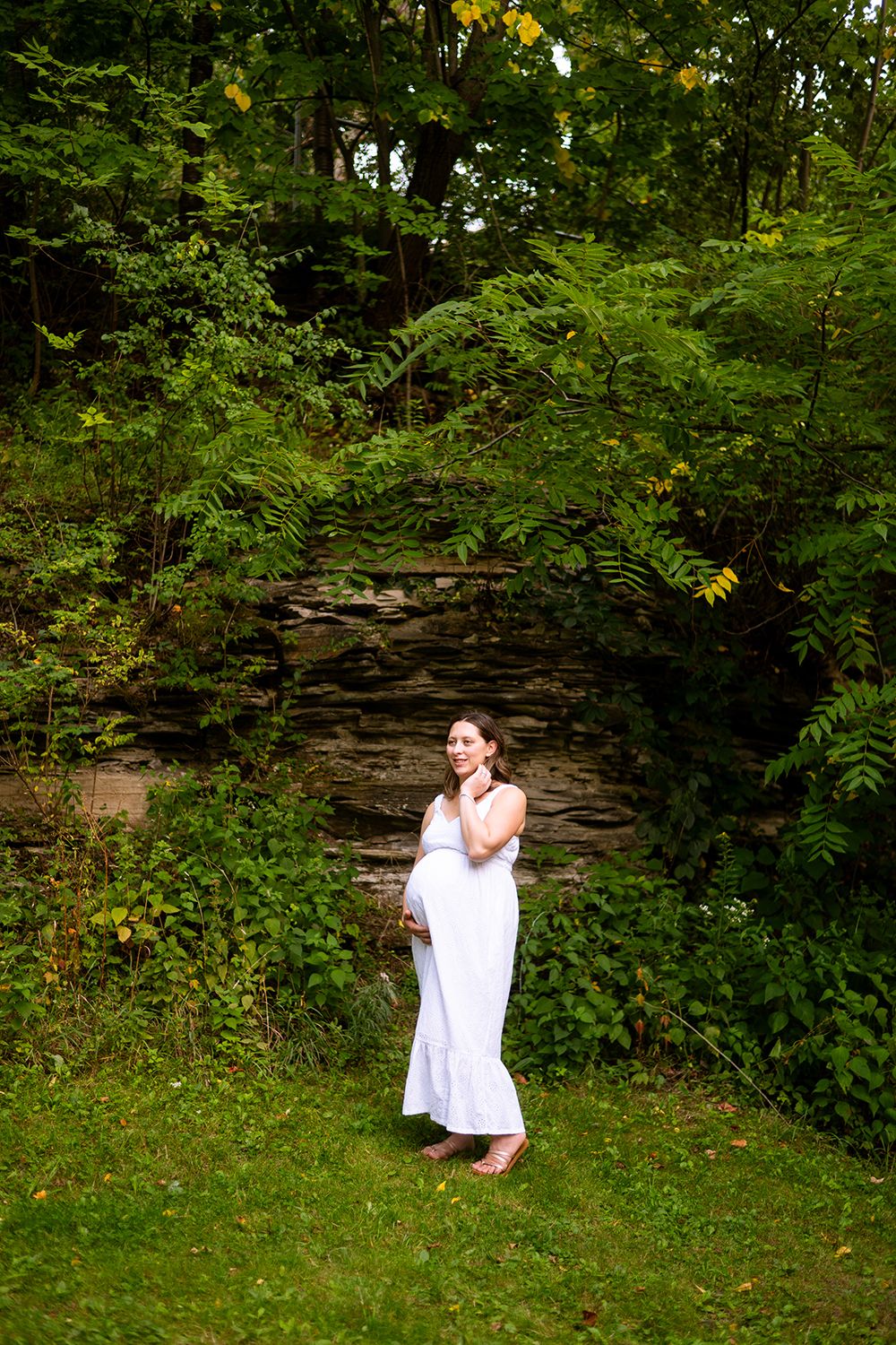 A sequence of images showing a person in a flowy white dress dancing gracefully against a backdrop of lush greenery and stone walls.