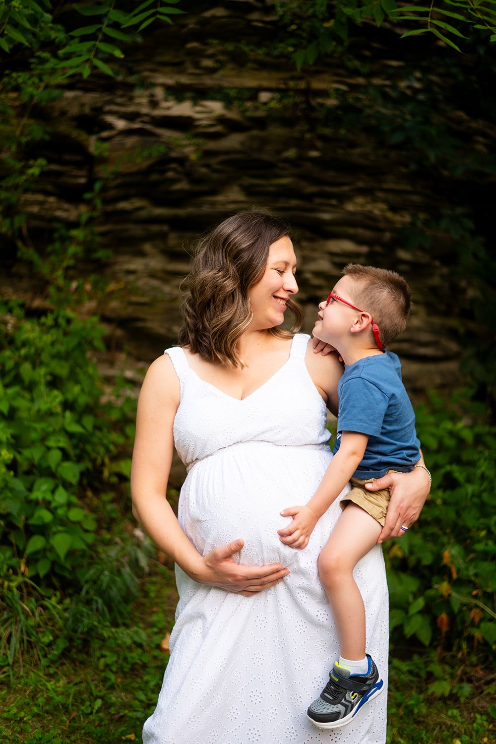 A series of joyful outdoor portrait moments captured near tall trees in a park setting.