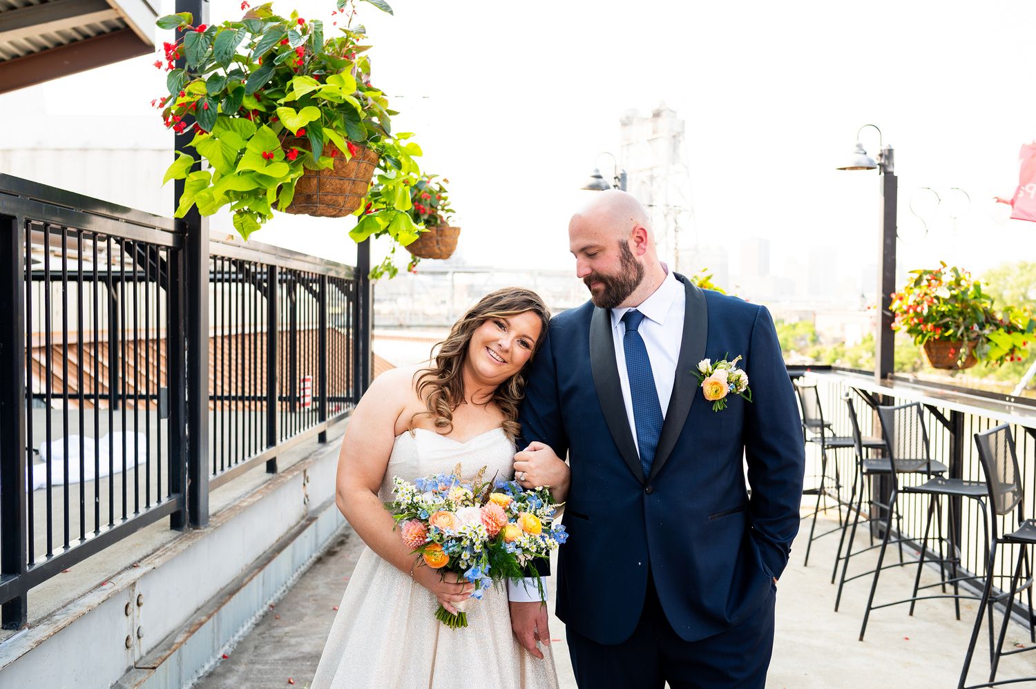 A series of romantic wedding photos showing a couple on an outdoor terrace with hanging plants and railings.