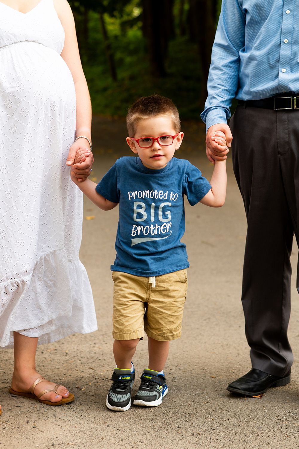 Close-up shots showing details of coordinating blue and white outfits worn by family members outdoors.