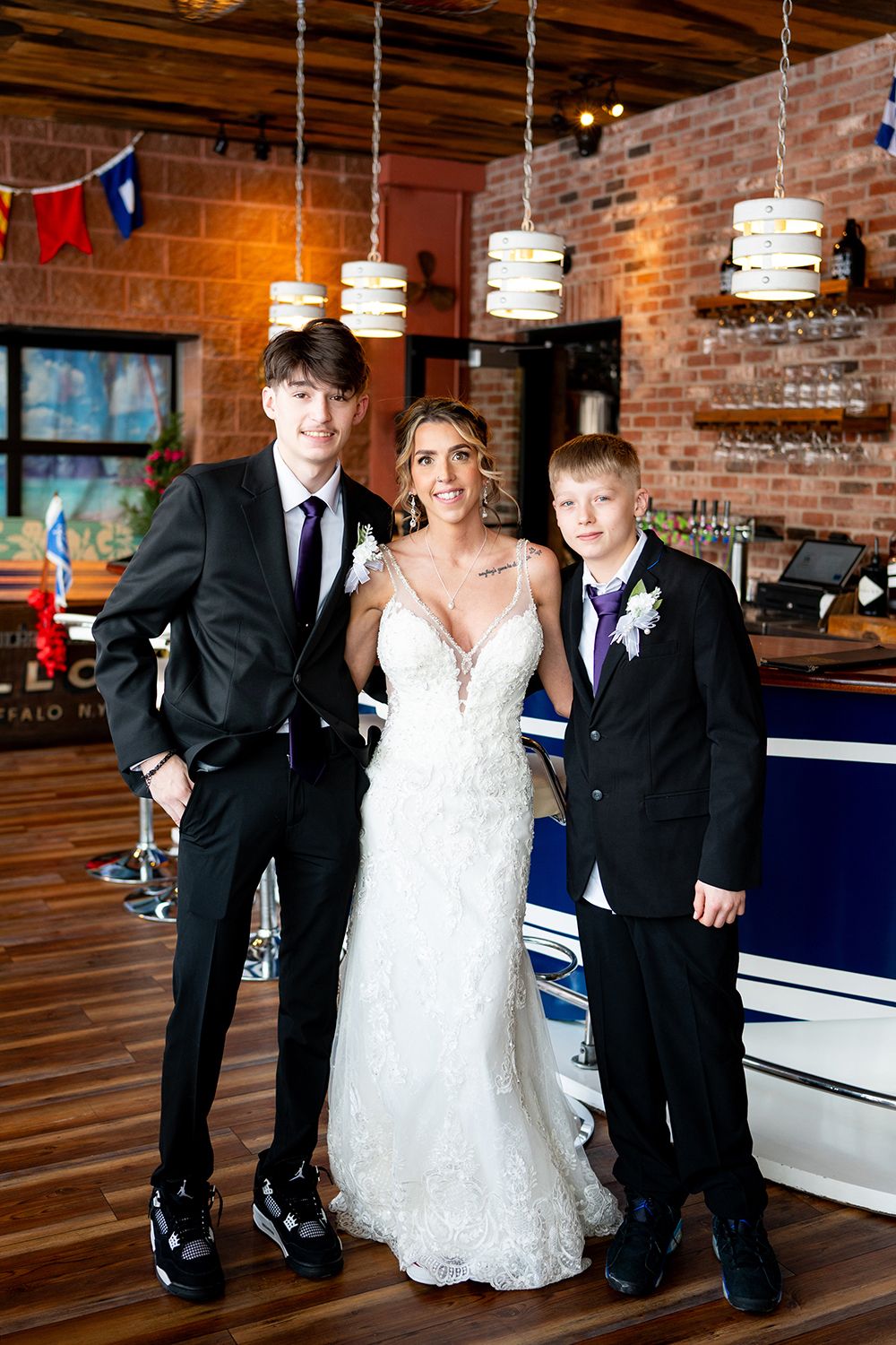 Wedding celebration in an industrial-chic venue with exposed brick walls and modern pendant lighting.
