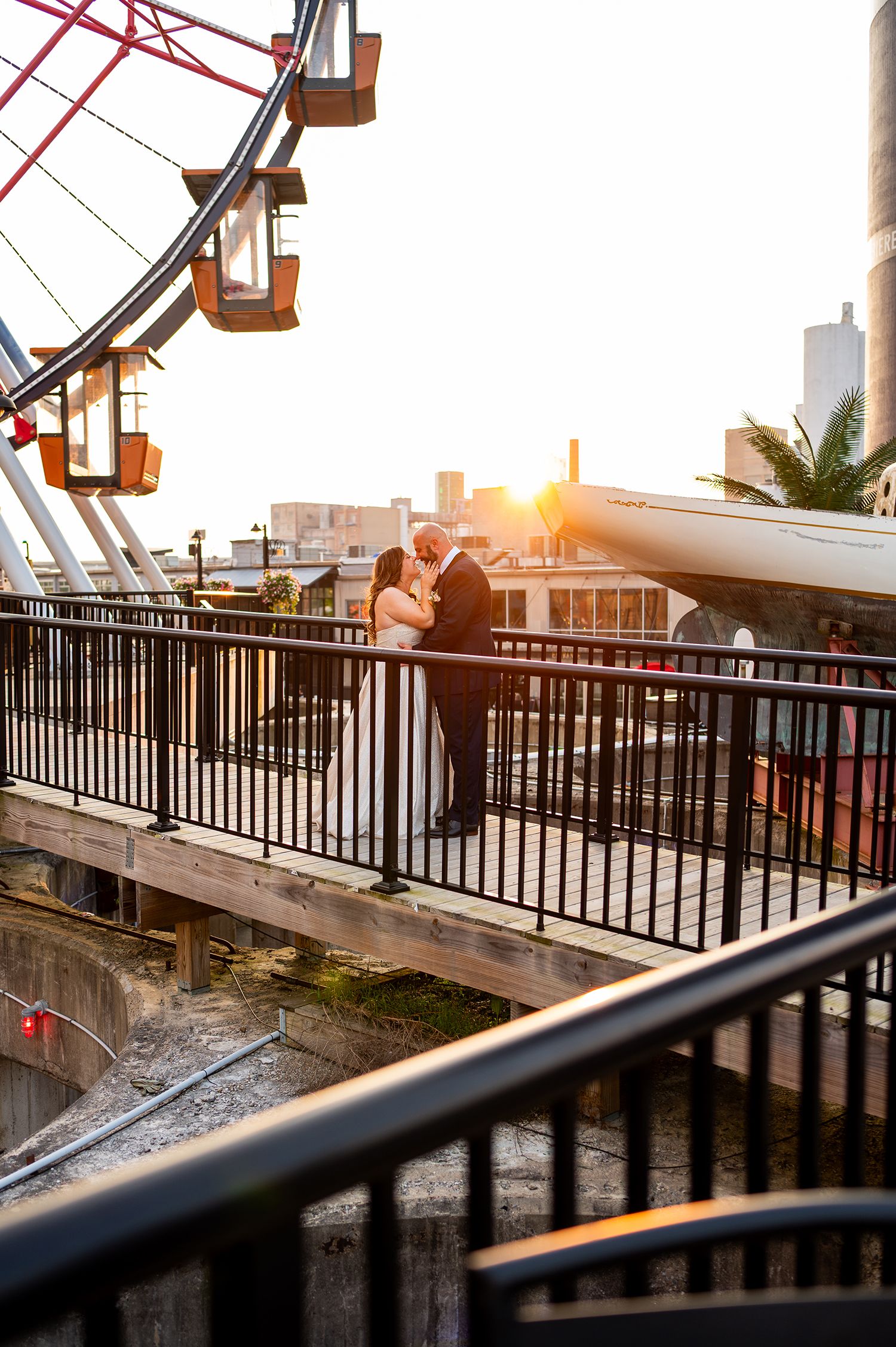 Wedding couple's sunset silhouettes captured in sequence along an outdoor balcony with industrial lighting.