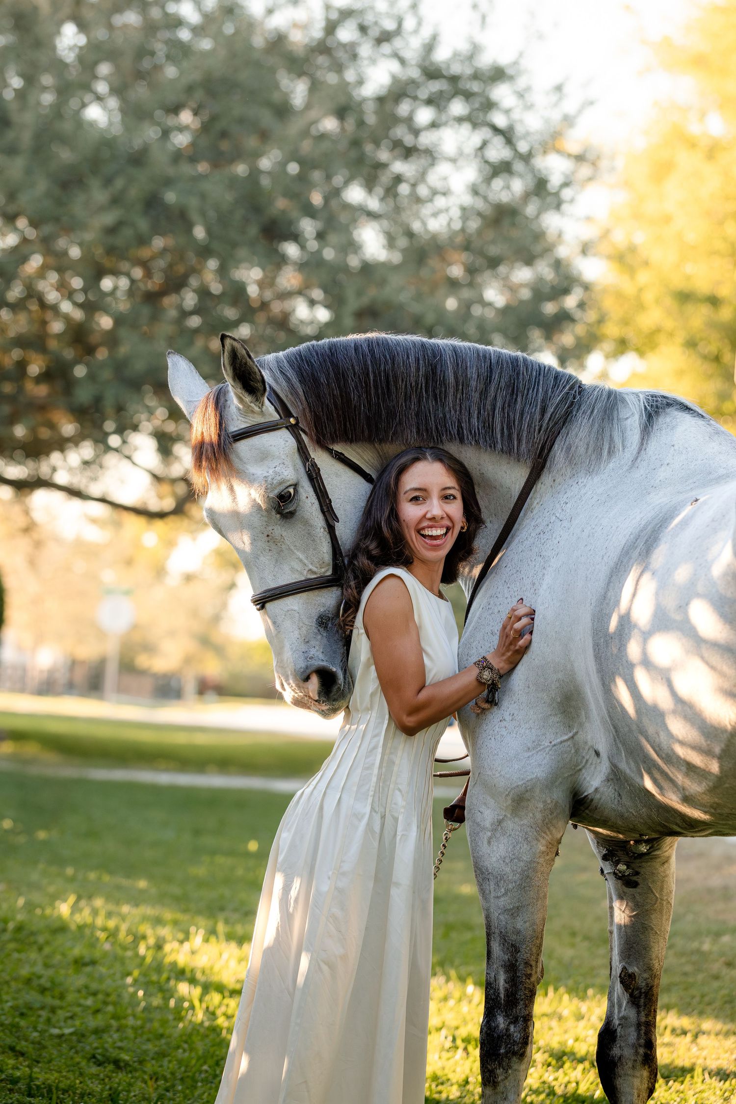 A series of photos showing a joyful moment with a beautiful white horse in a sunlit park setting.