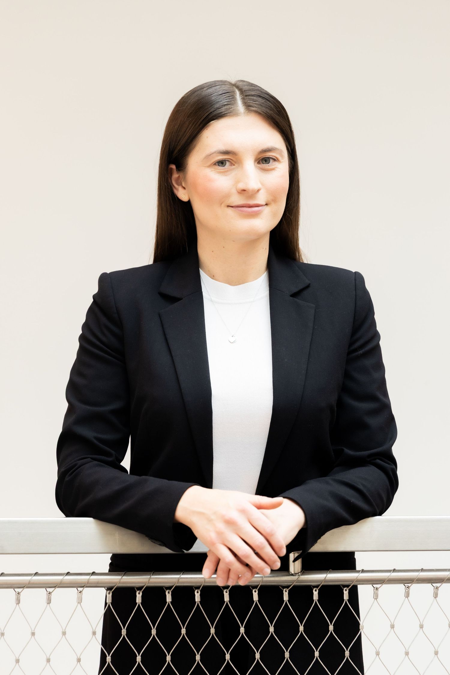 Professionelles Business-Porträt einer Frau in formellem Outfit, das Selbstbewusstsein und Professionalität ausstrahlt.