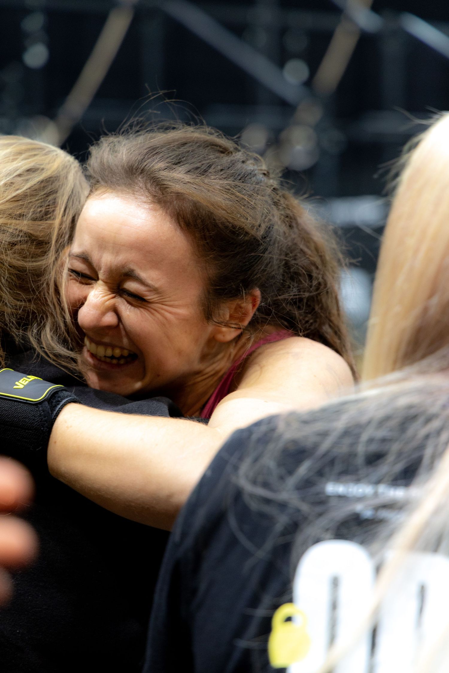 Emotionale Aufnahme einer Frau bei einem sportlichen Moment, die ihre Freude und Erschöpfung nach einem intensiven Training zeigt.