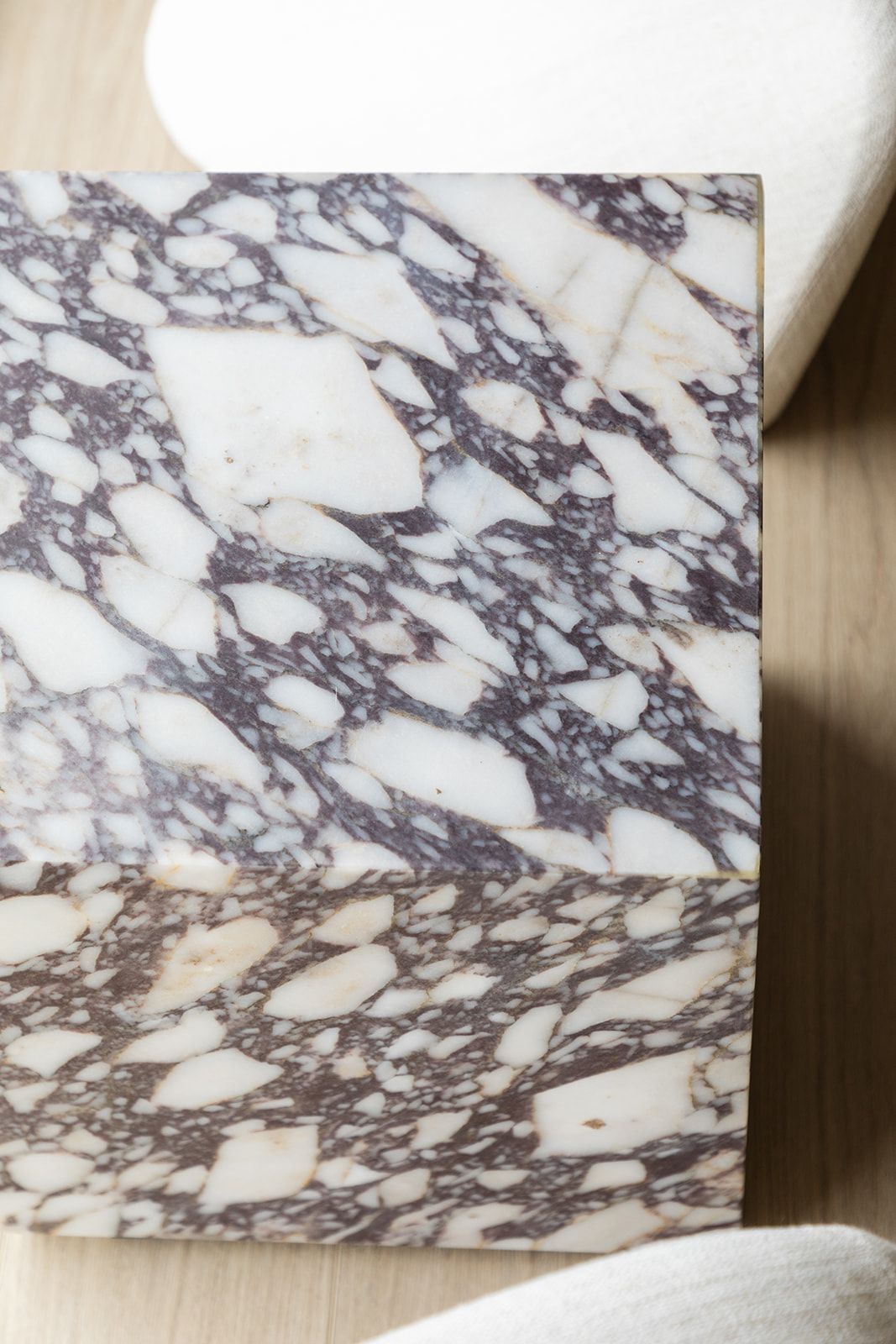 Close-up detail of luxurious white marble with distinctive purple-gray veining patterns across its polished surface.