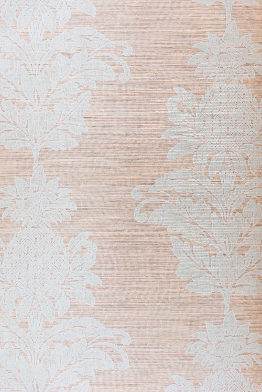 Elegant white damask floral pattern on a soft peach or blush colored textured background.
