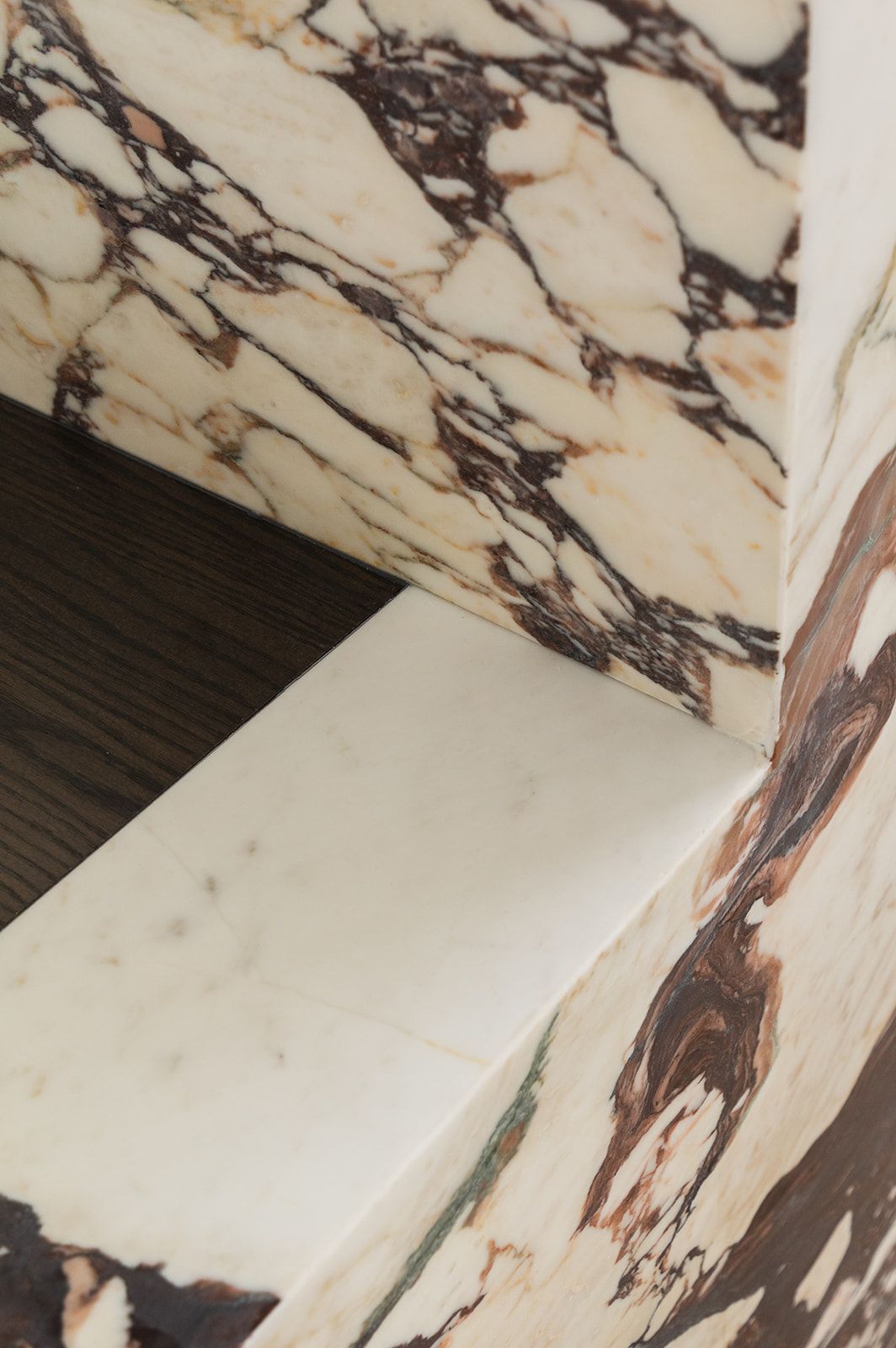 Close-up detail of luxurious marble surface showing dramatic white and brown veining patterns.