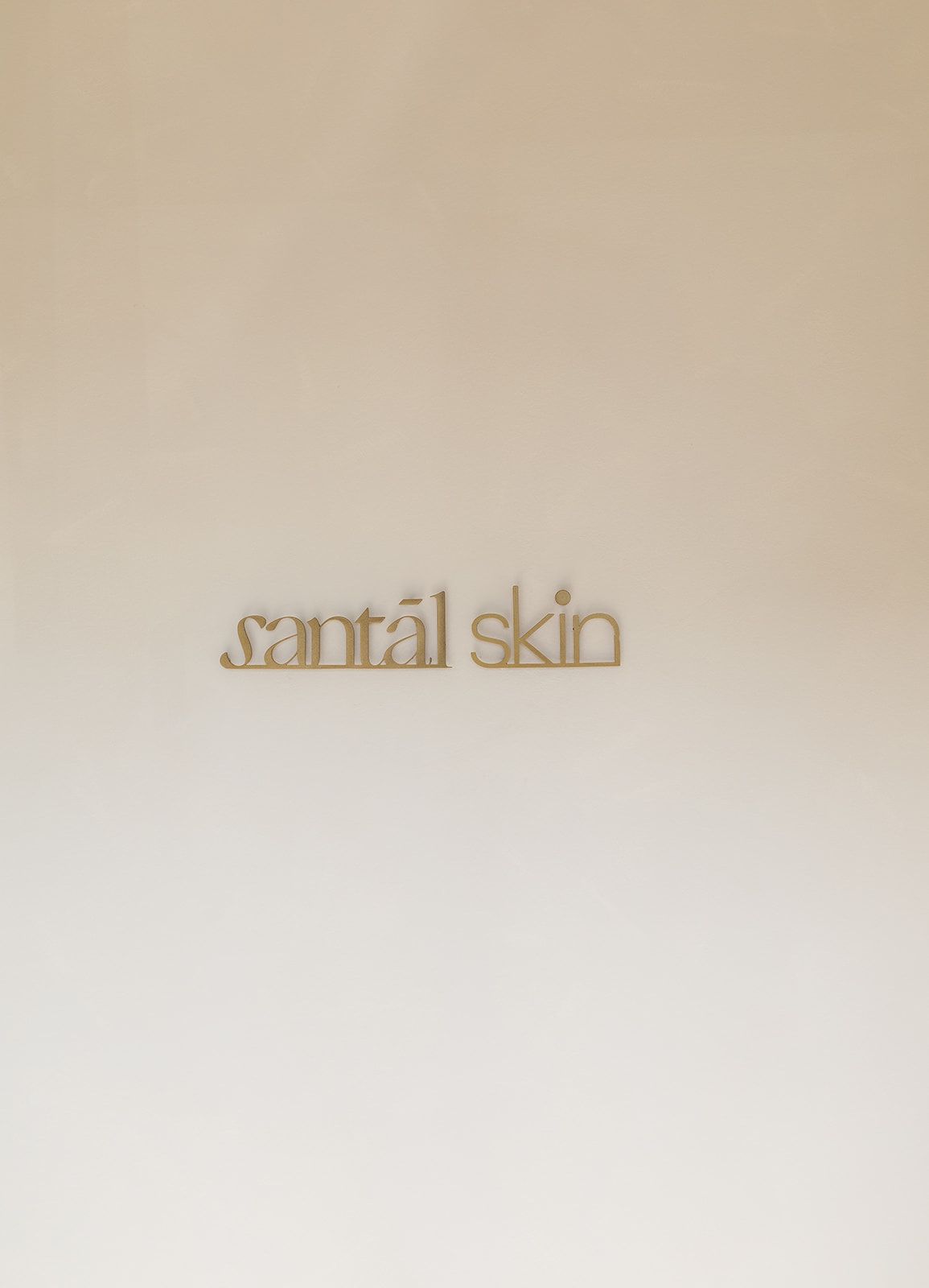 Text logo reading 'santal skin' in minimalist stylized font on a neutral beige background.
