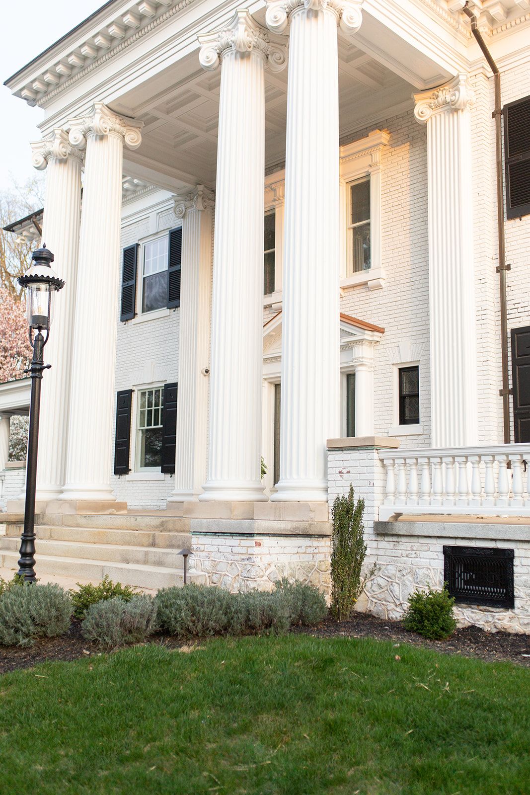 Impressive Greek Revival facade with towering fluted columns and ornate cornices.