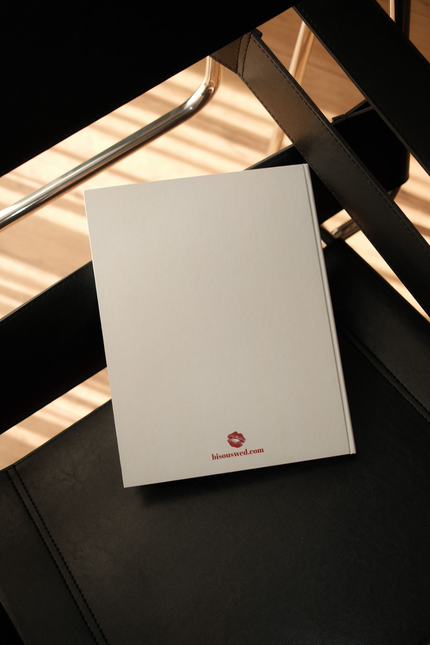 A series of white business cards shown at different angles on a dark surface with dramatic lighting and shadows.