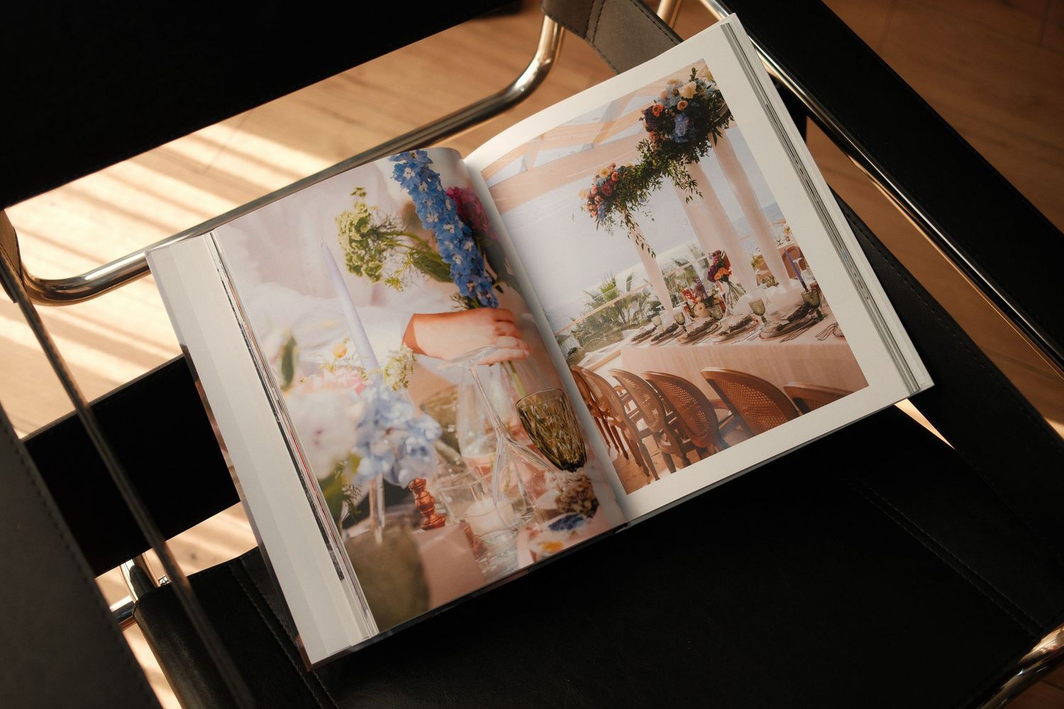 Several open books with colorful illustrations and artwork are displayed on a dark surface in a fanned arrangement.