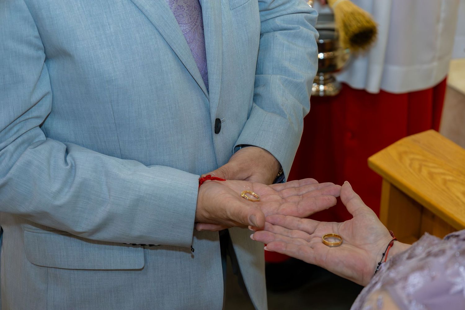 A person in a light blue blazer demonstrates a hand washing technique in a series of six sequential steps.