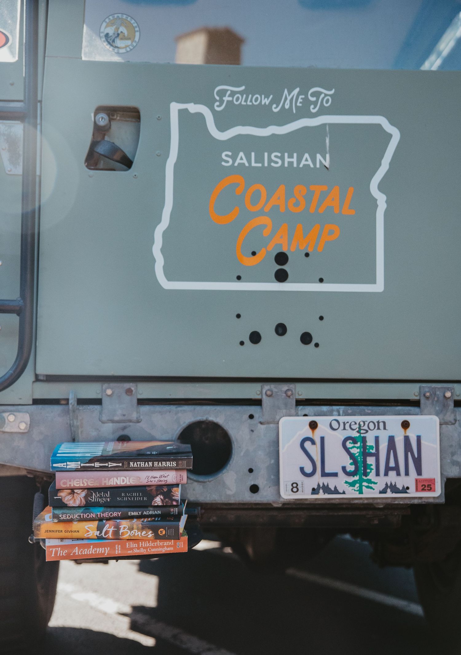 A collection of stickers and labels on a surface showing text including 'Salishan' and 'Coastal' in various styles.