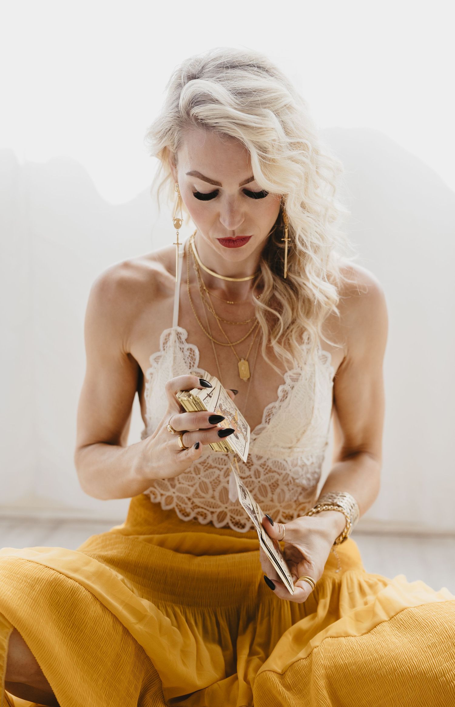 Fashion photo series showing a flowing mustard yellow dress against a bright white backdrop.