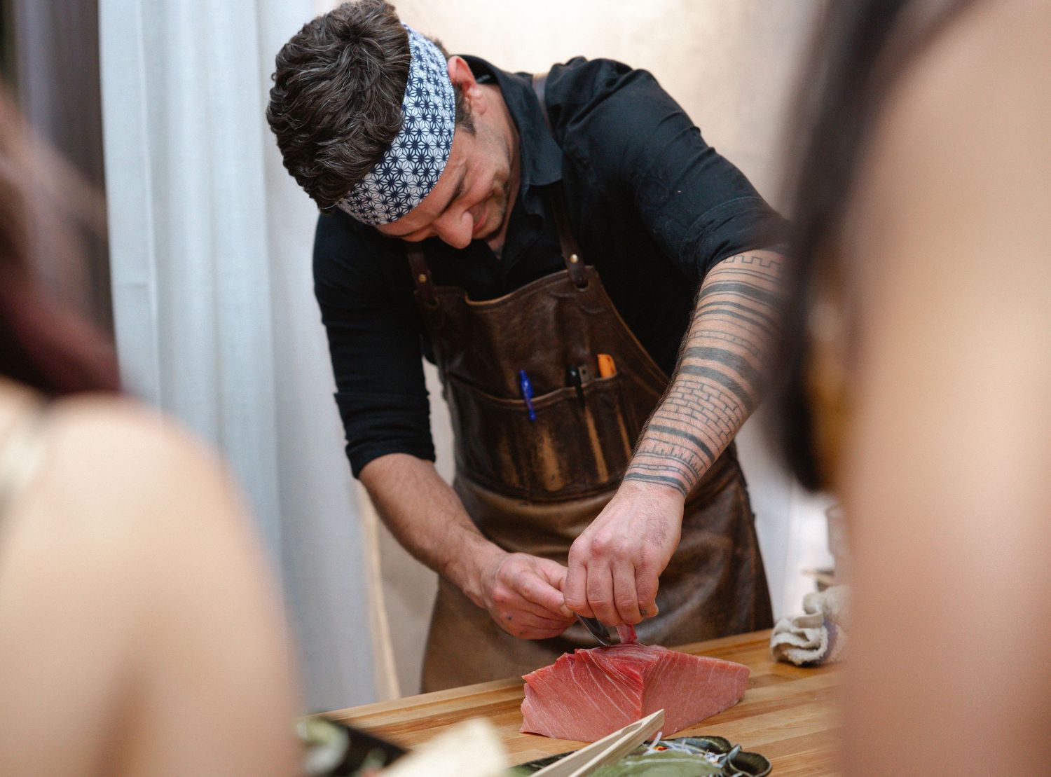Close-up shots of hands preparing food or ingredients on a wooden cutting board.