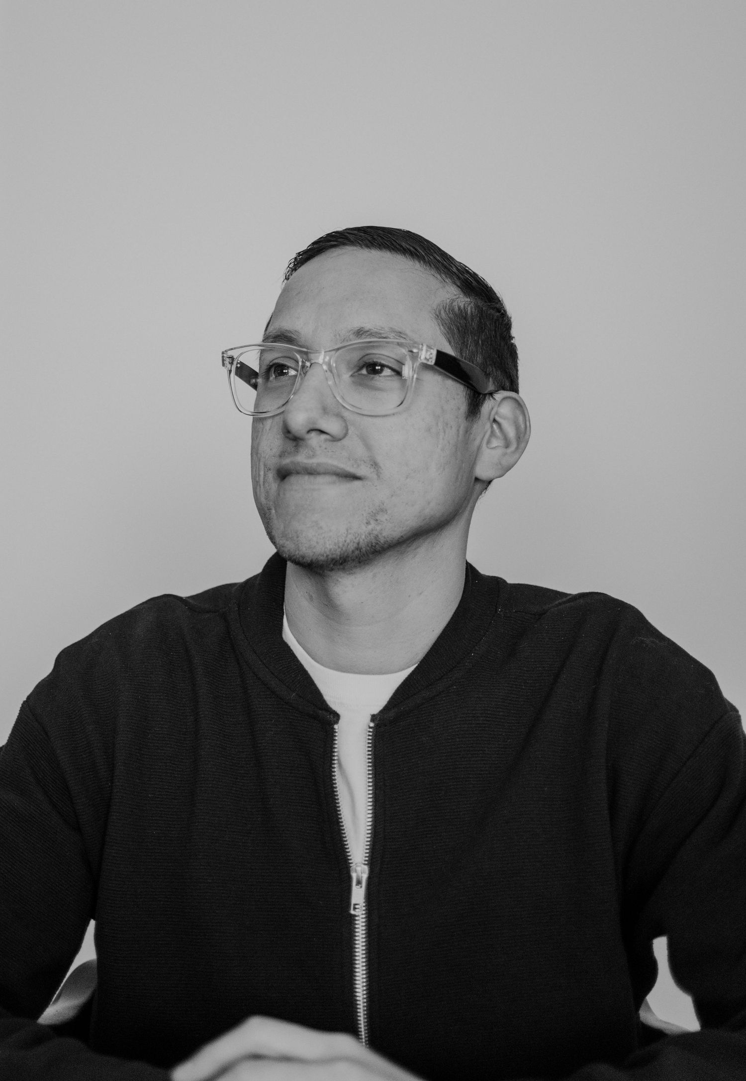 A black and white photo series showing someone wearing glasses and a dark shirt turning their head in different positions.