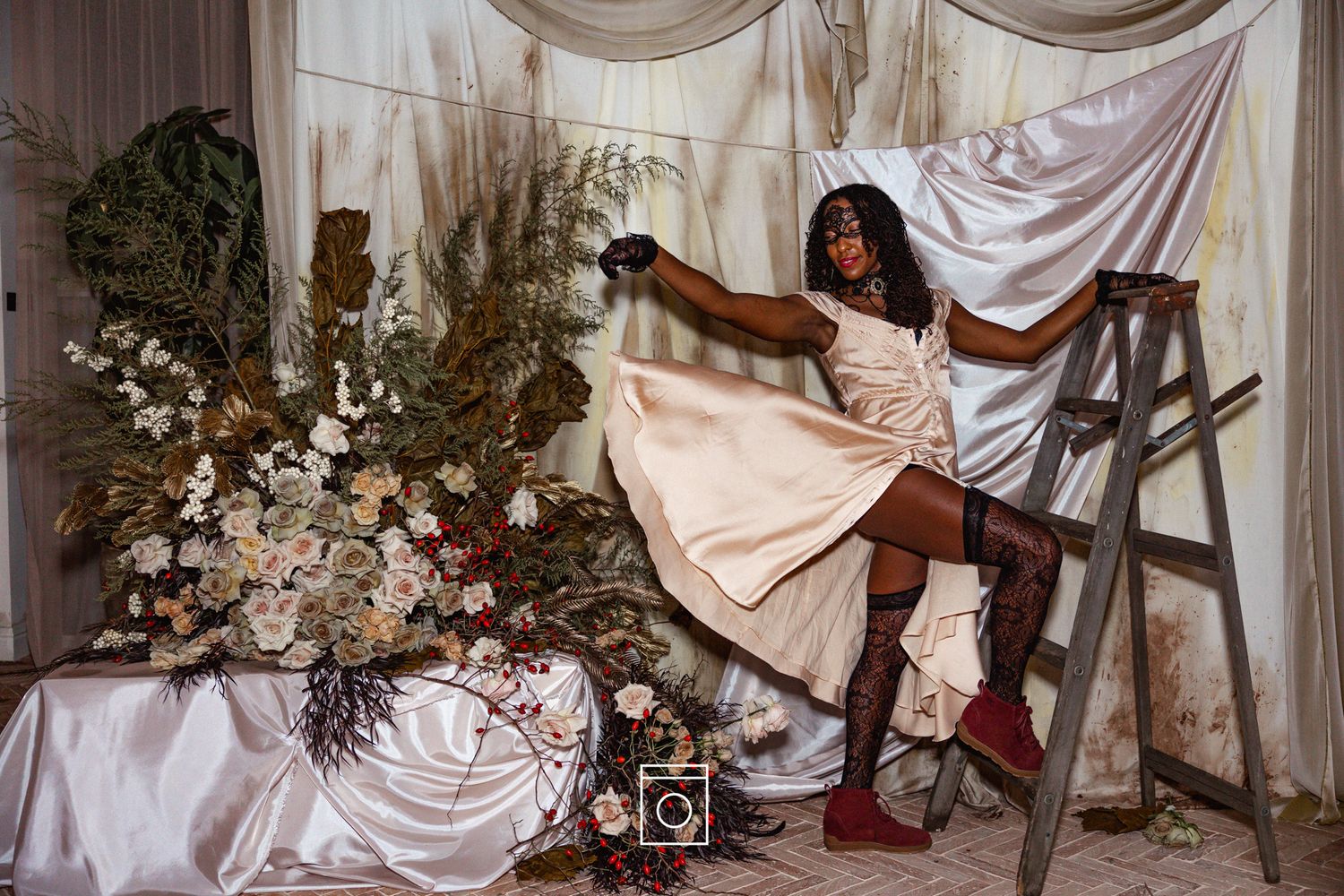 White fabric drapes create an elegant backdrop for a wedding ceremony setup with floral arrangements and decor.