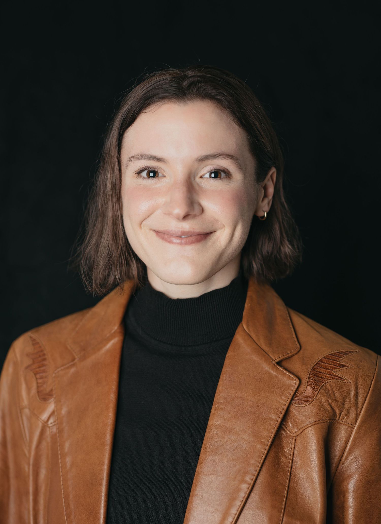 A person wearing a brown leather jacket and black turtleneck poses against a dark background in a sequence of photos.