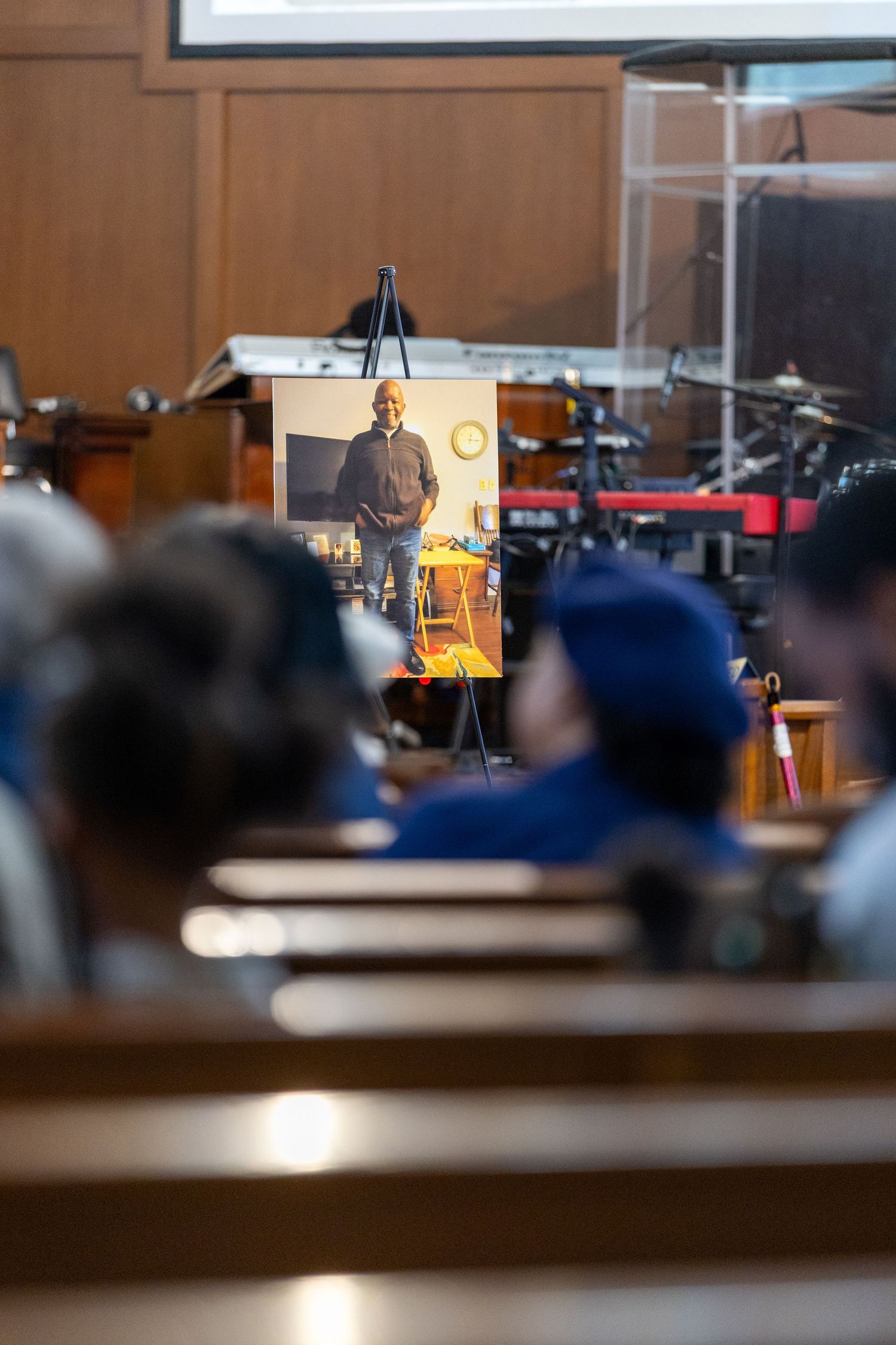 Blurred interior view of church sanctuary with desk lamps and pews.