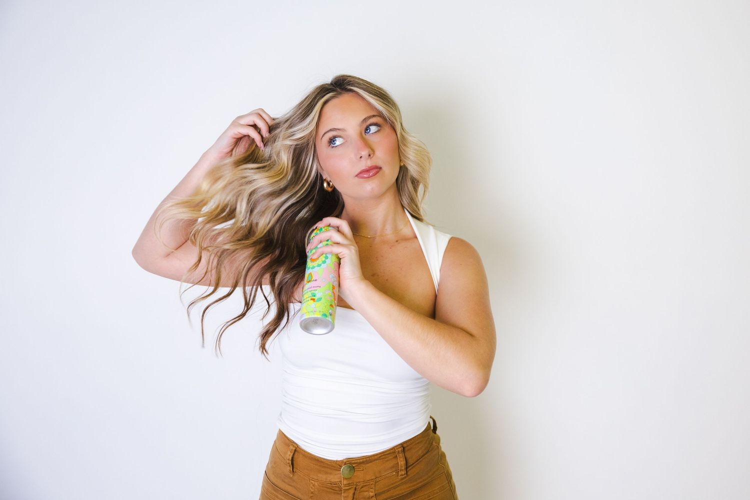 A fashion portrait series showing playful poses against a white background.