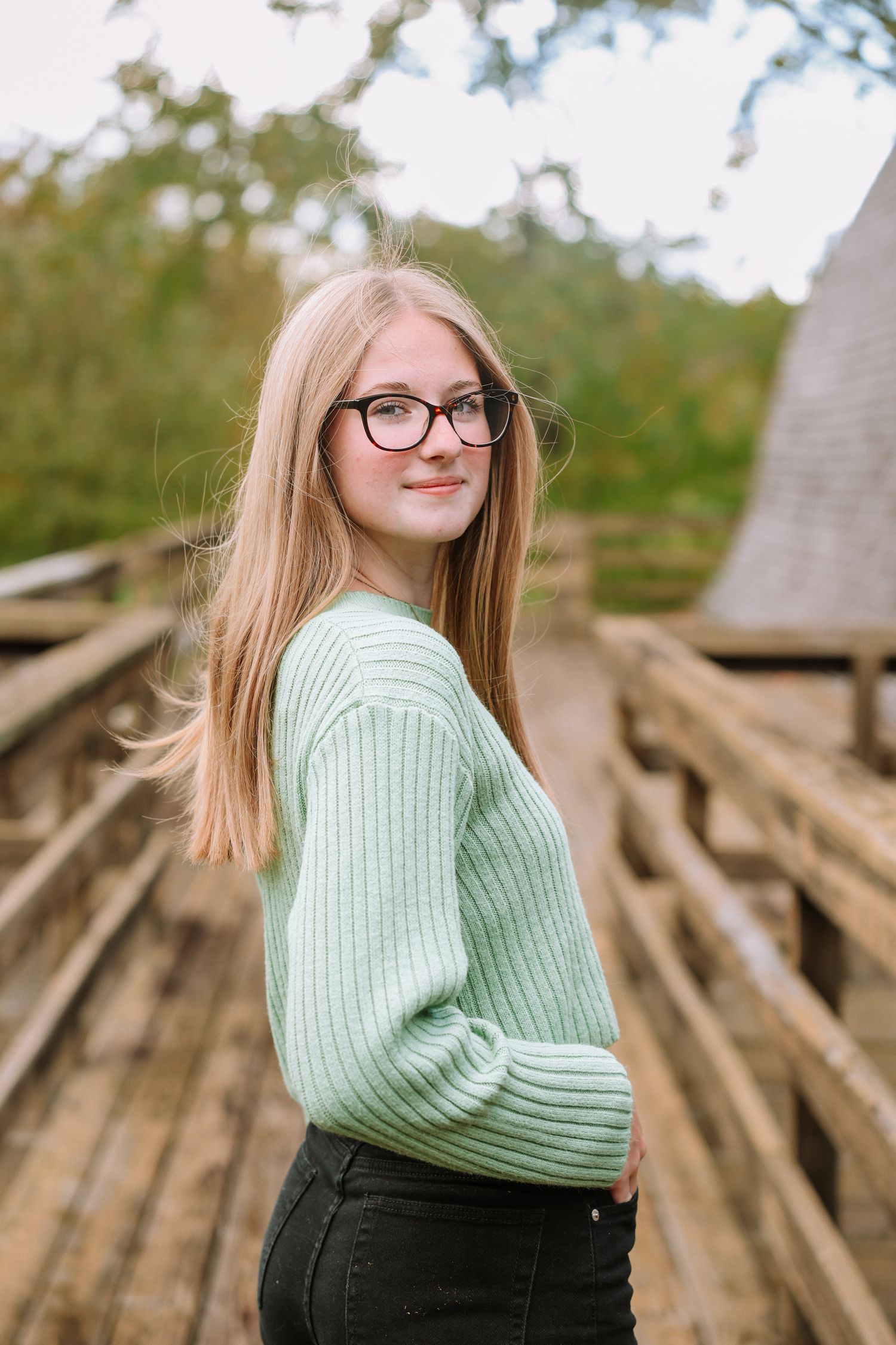 Autumn portrait on wooden boardwalk with natural background.