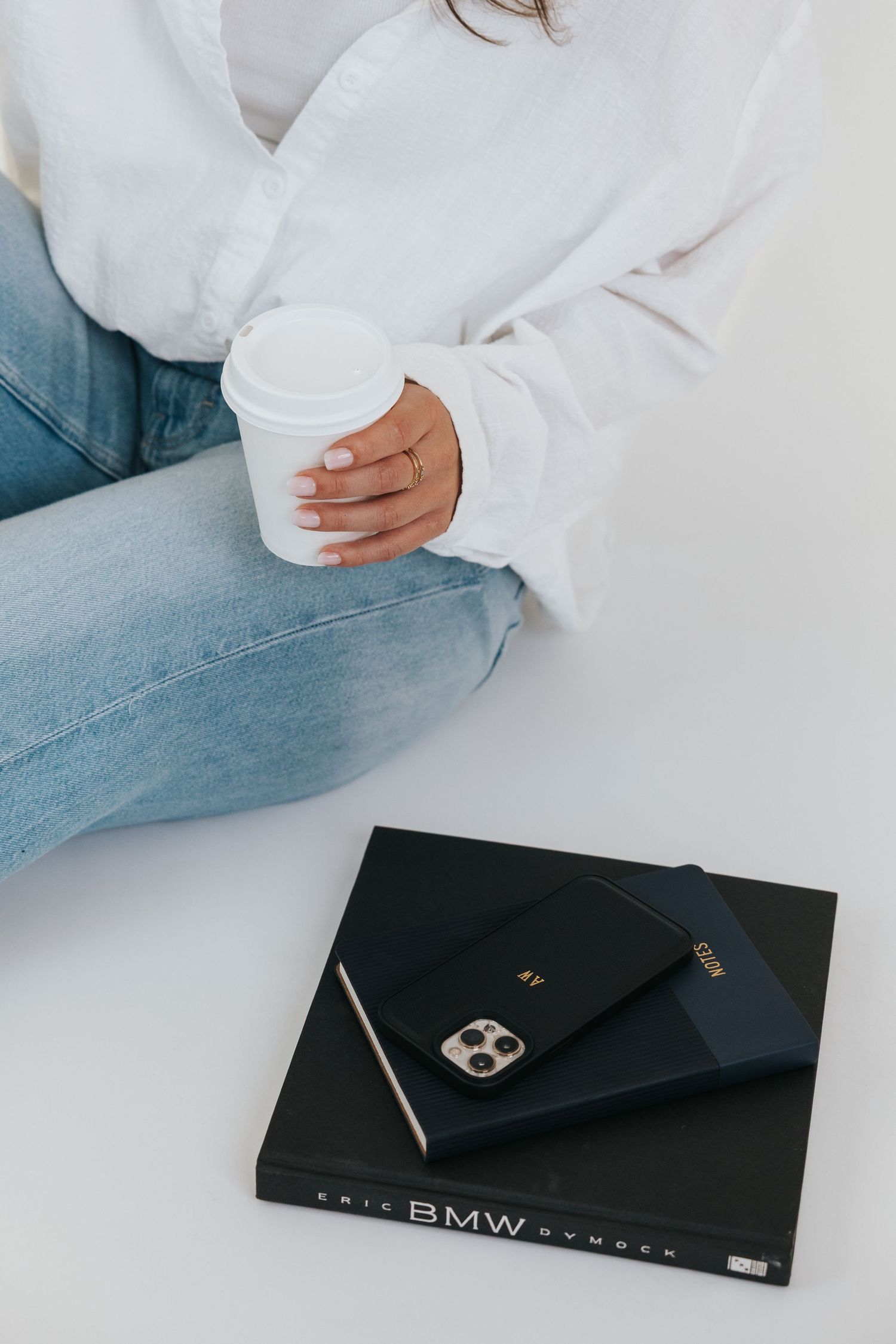 Lifestyle product photography featuring BMW branded book on white surface.