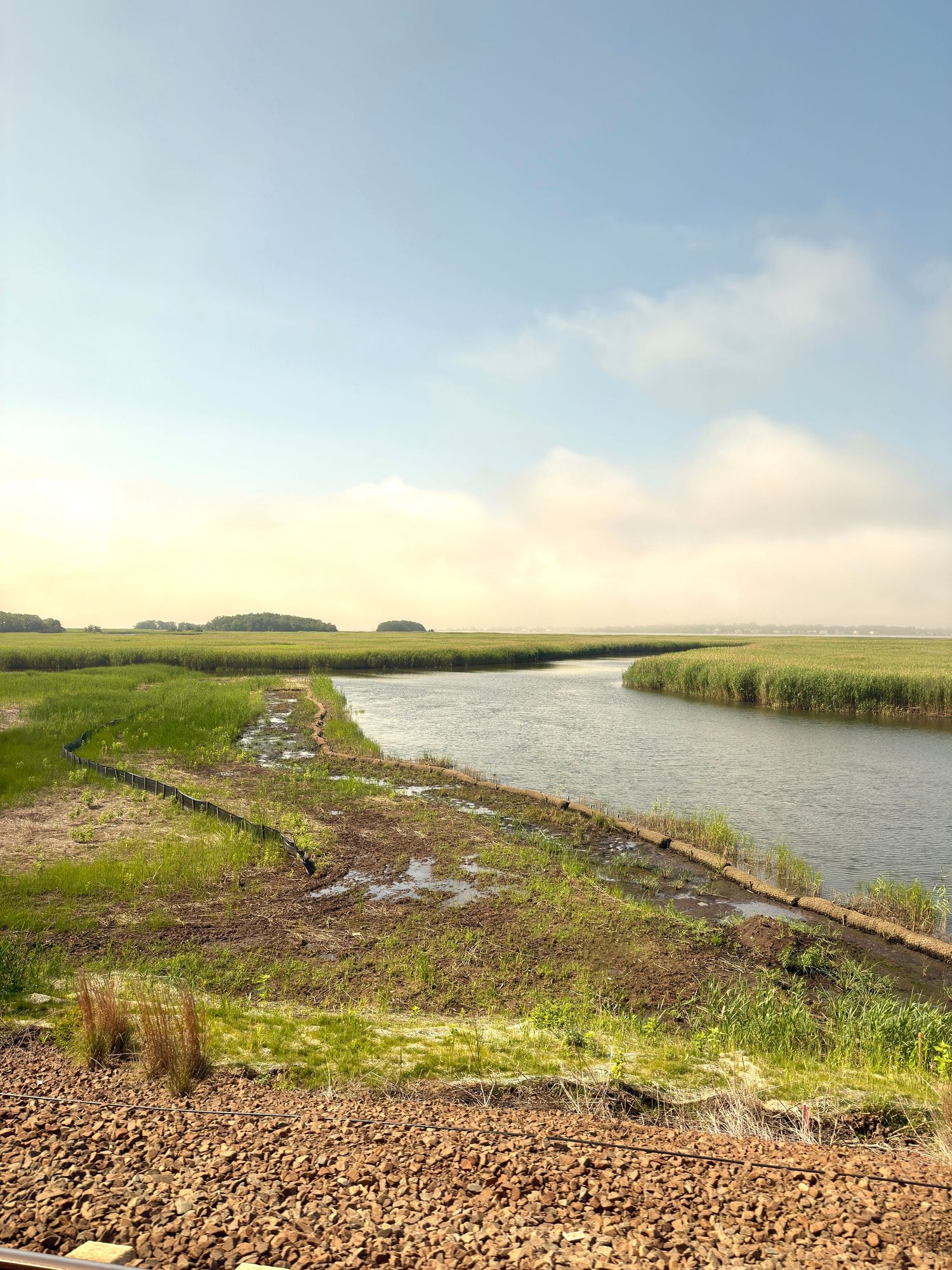 The stream flows between two grassy areas.