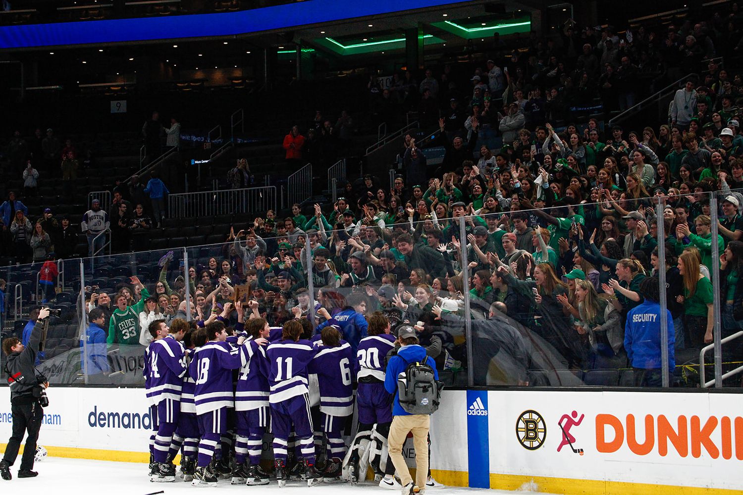 The hockey team celebrates a victory with their stands