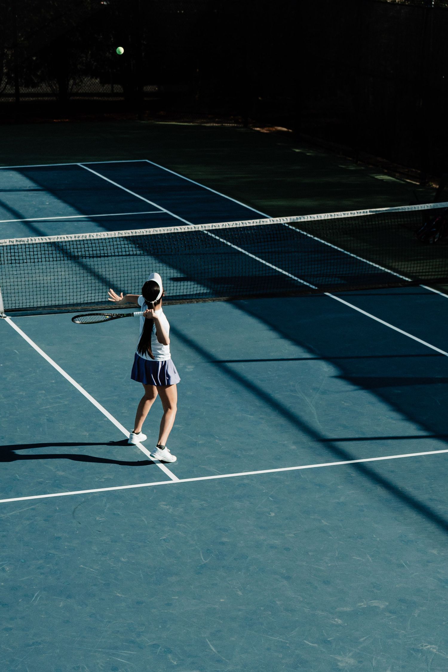A tennis player prepares to return the ball to their opponent.