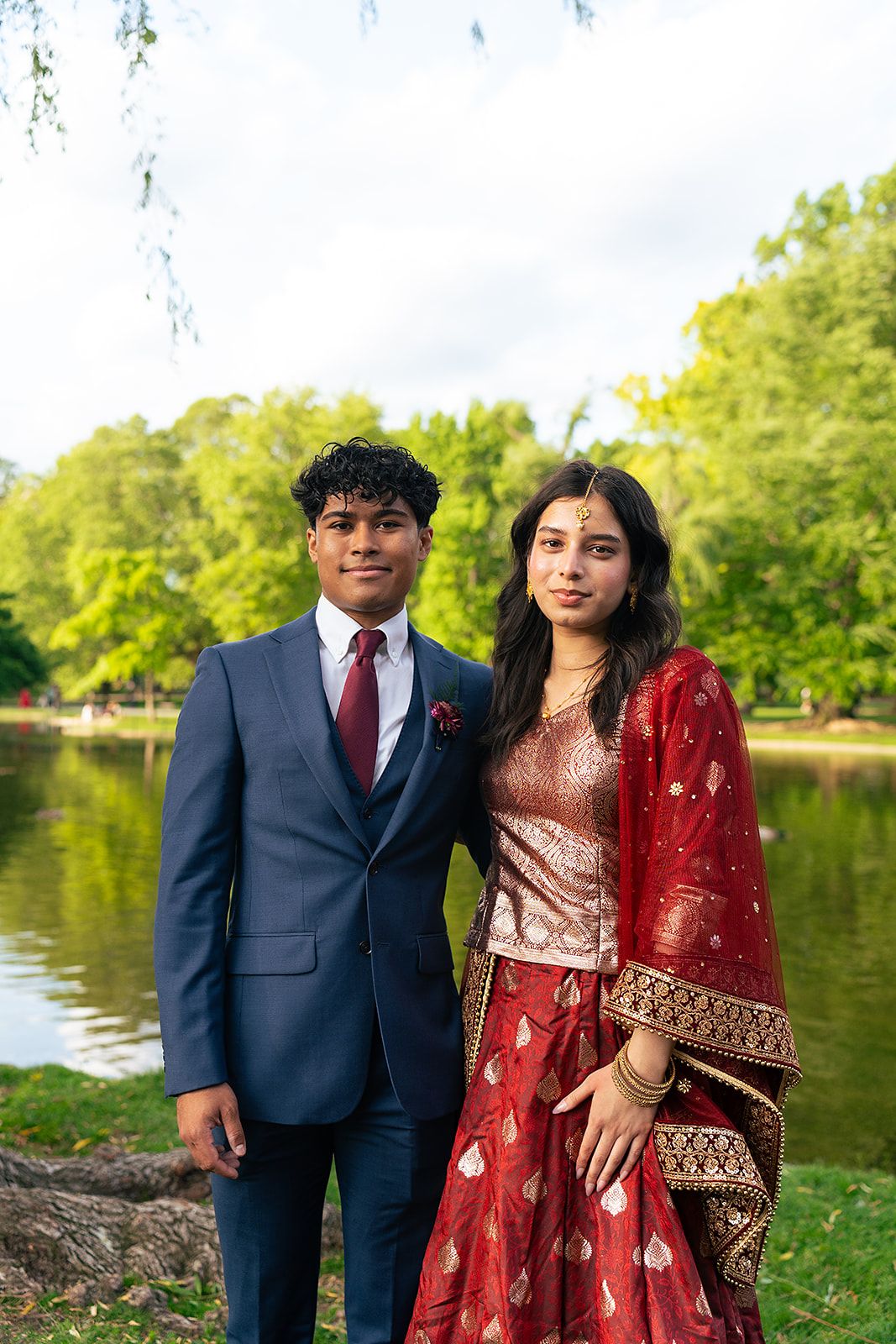 A prom couple poses in front of the Swan Pond at Boston Public Garden.
